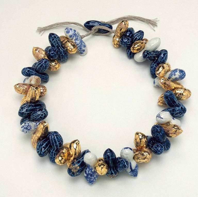 A big necklace that consists of gilt and painted ceramic 'peanut' beads.

Pauline Wiertz was originally trained as a ceramic artist at the Gerrit Rietveld Academy in the 1970s. Wiertz started making jewelry in 2000. She started with necklaces made