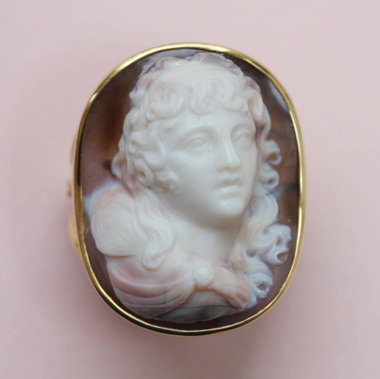 A 19th century deep agate cameo representing Apollo in a modern gold setting.

dimensions: 2.6 x 1.6 cm.
ring size: 17.25 mm. 7 US.