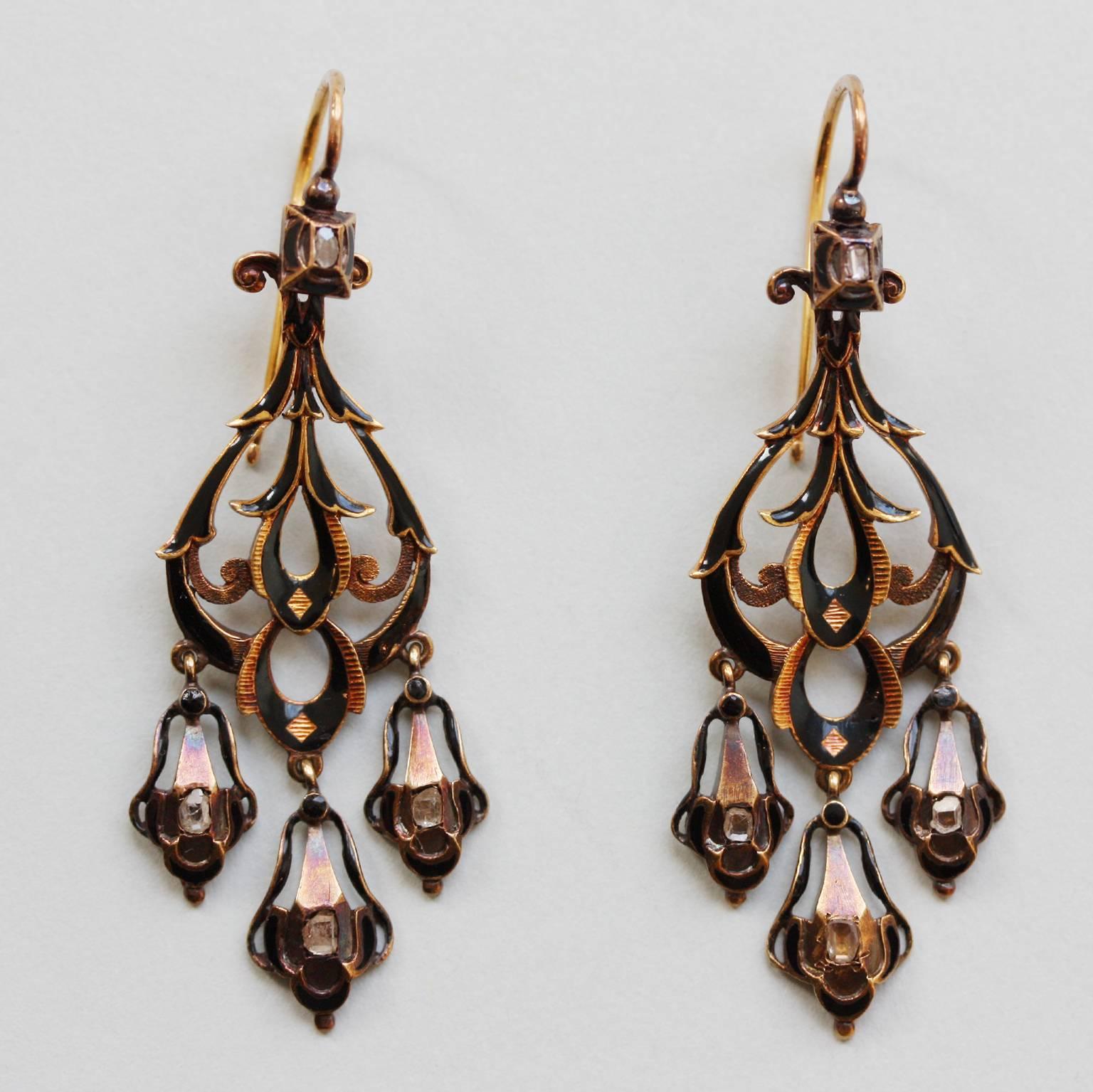 A pair of 18 carat gold neo renaissance earrings set with small table cut diamonds, both sides decorates with black enamel, 19th century, France.

dimensions: 5.6 x 2.2 cm.
weight: 12.1 grams