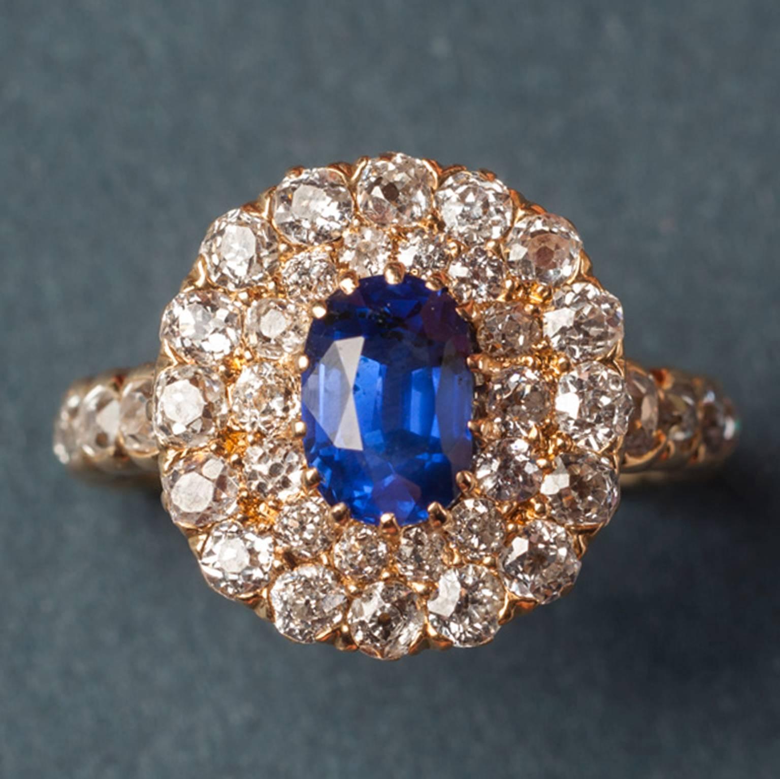 An oval yellow gold Edwardian ring set with a natural blue sapphire (app. 1.5 carats) surrounded by two rows of old cut diamonds, the shank is also set with old cut diamonds (2.5 carats in total), USA, circa 1910.

weight: 5.4 grams
ring size: