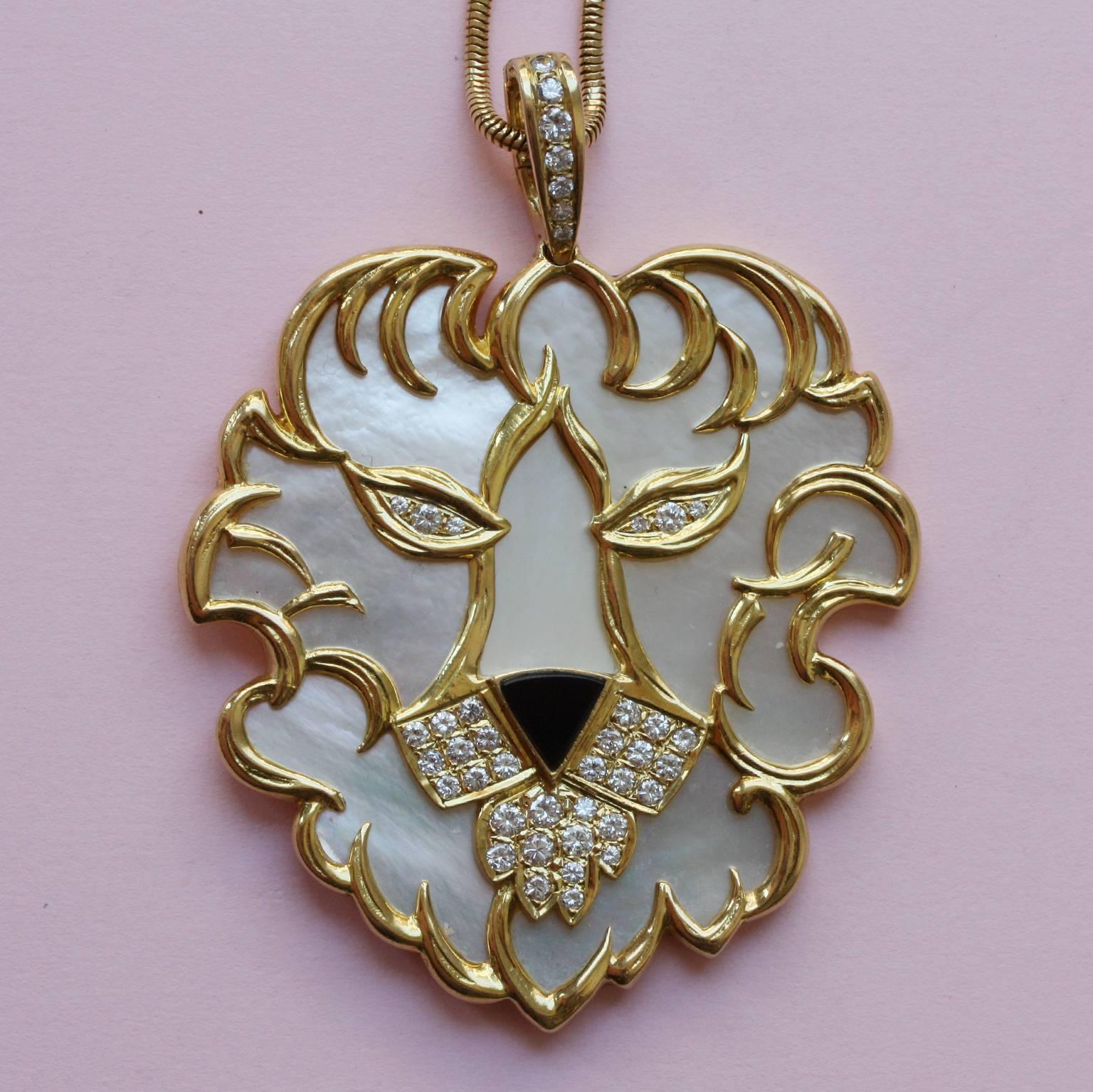 A large lion pendant of mother of pearl asymmetrical set in textured gold for the fur, with an onyx nose and brilliant cut diamonds for eyes and whiskers and beard (app. 1.6 carats) and also in the hoop of the pendant, with French masters mark and
