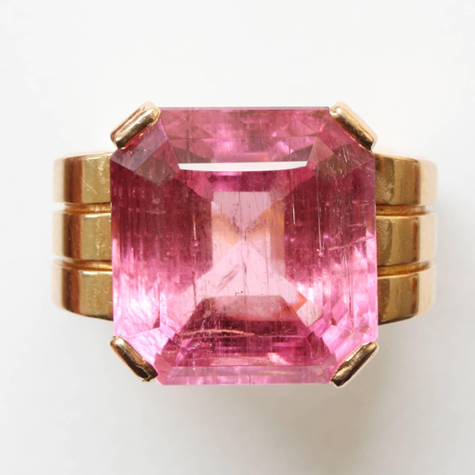 A large 18 carat rosé gold tank ring set with a square step cut bright pink tourmaline (app. 20 carats), masters mark: Henry Fougery and fully signed: Mathy, Paris for Charles Mathy, France. circa 1925-1930.

weight: 21.4 grams
ring size: 18