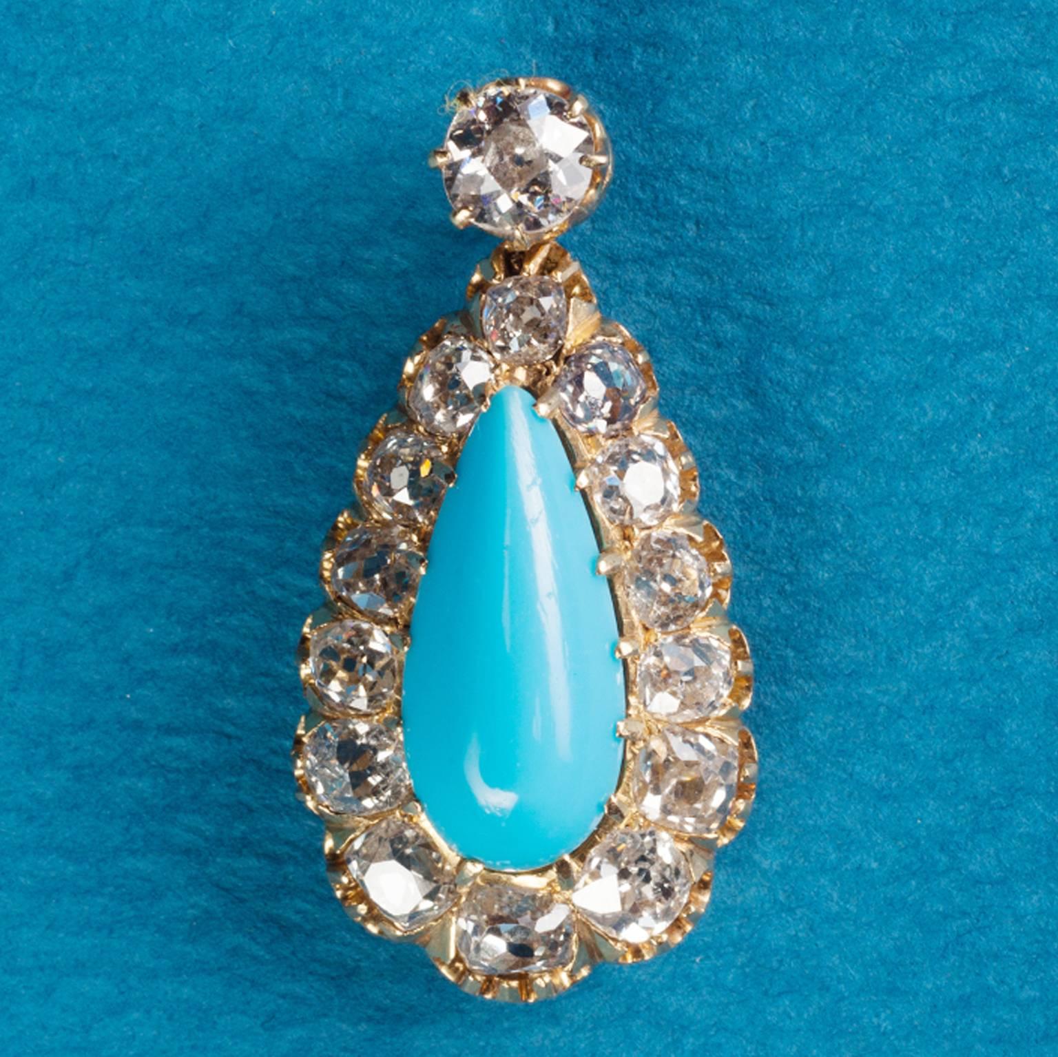 An 18 carat yellow gold drop shaped pendant set with 15 graduating old cut diamonds (app. 2 carats in total) and a cabochon cut drop shaped blue glass as center stone, France, 19th century.

weight: 4.5 grams
dimensions: 3 x 1.5 cm