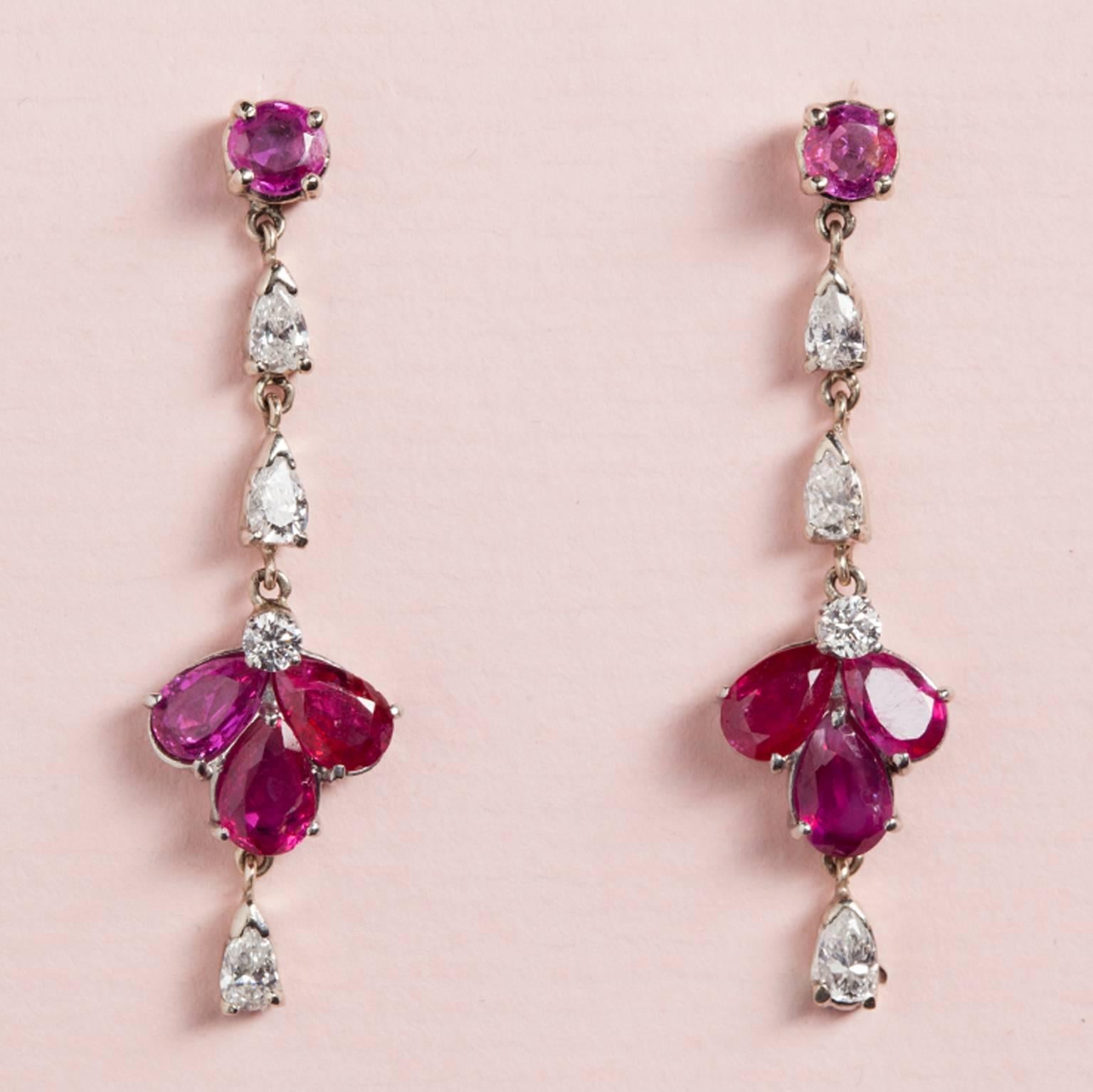 A pair of white gold earrings set with diamond and Burma rubies (app. 2.75 carats), USA, circa 1950.

weight: 5.2 grams
dimensions: 4 x 1.1 cm