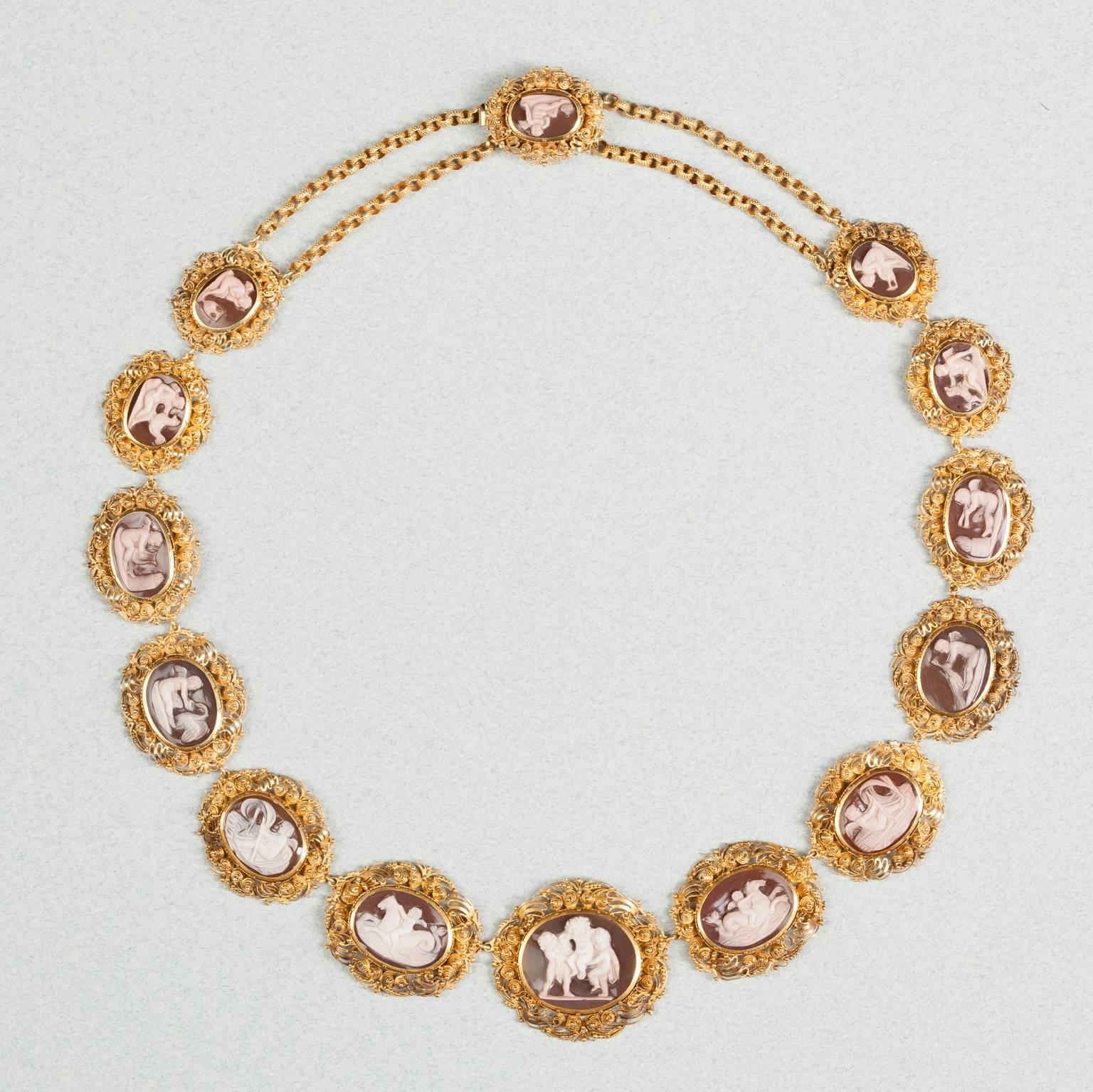 A 15-carat gold necklace set with 14 sardonyx cameos with genre scenes of Amor, the god of love, set in a rich Georgian mount with fine spirals (cannetille) and granules (grainti), a double textured chain links the last cameos to the clasp,