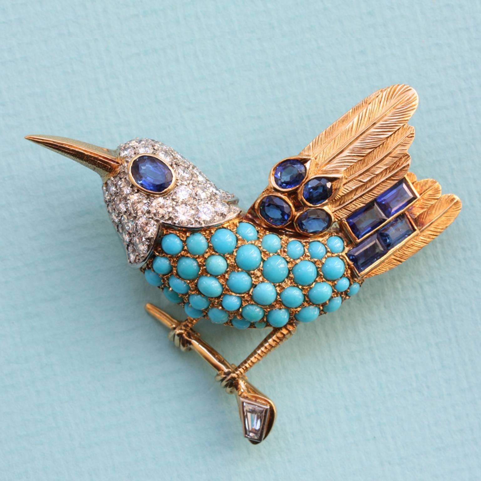An 18-carat gold bird set with cabochon-cut turquoises and brilliant-cut diamonds (app. 2 carats) set in platinum; the eye and feathers are set with oval- and baguette cut-sapphires (app. 2 carats). The bird is perched on a tiny branch with a