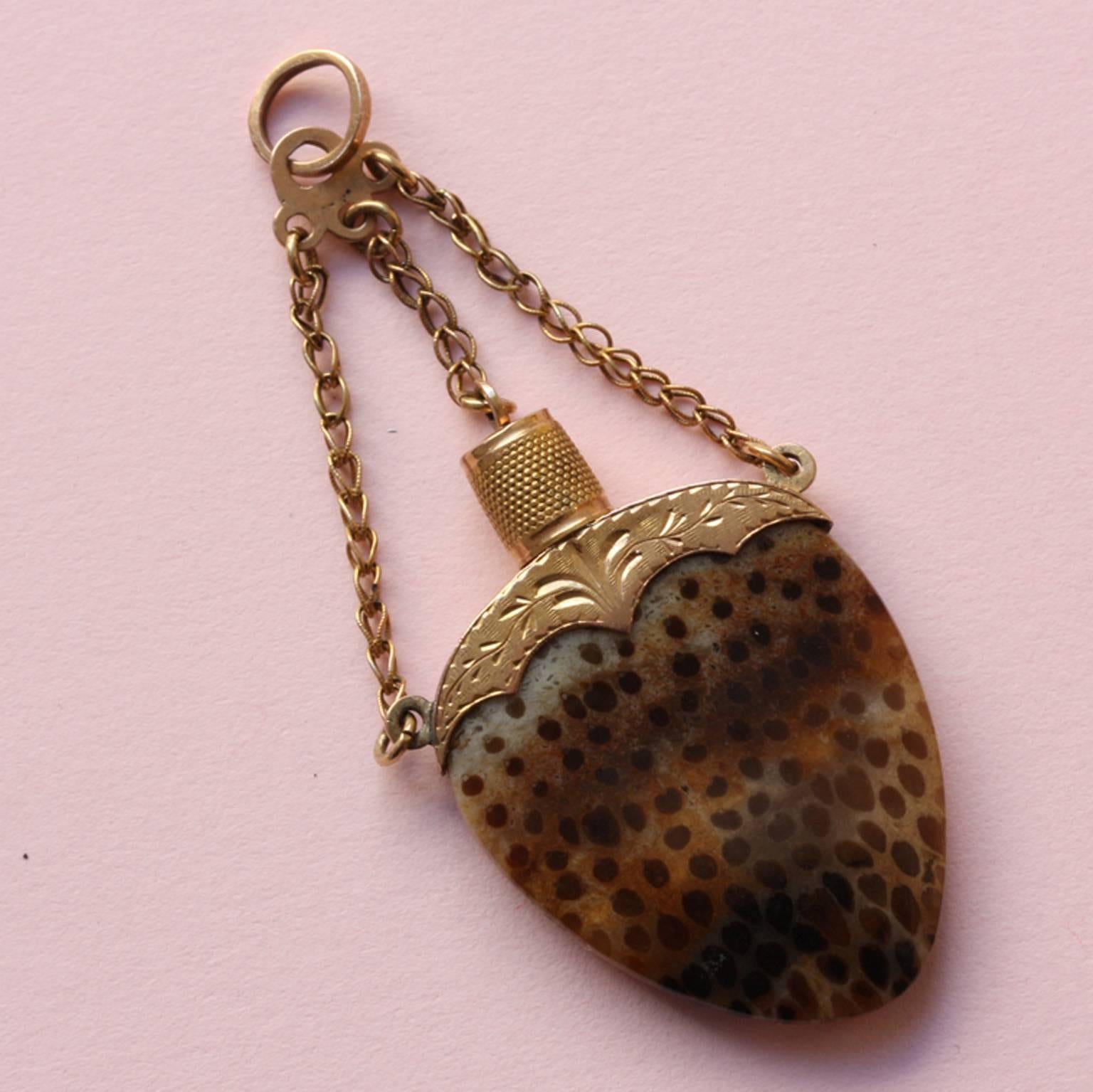 An early 19th-century 18-carat rosé gold and palmoxylon - or petrified palmwood - pendant simulating a perfume flask with stopper on a fine woven chain, France, circa 1810. This unusual fossil was formed between the Cretaceous and the Miocene