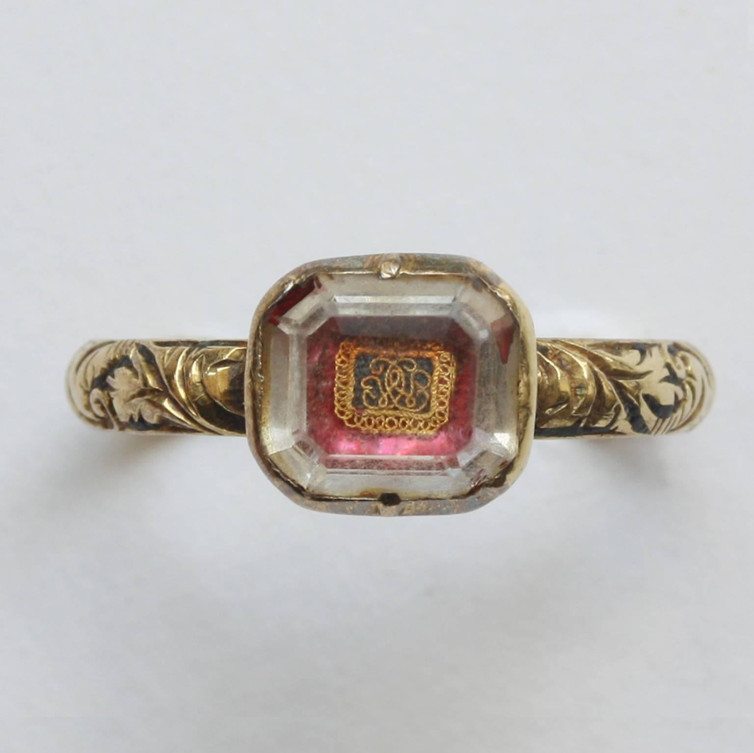 A delicate and rare gold Stuart crystal ring set with a facetted rock crystal on red foil with a gold wire cypher (CWC), the shank has floral decoration and traces of black enamel, English, late 17th century. Mint condition.

weight: 2.6