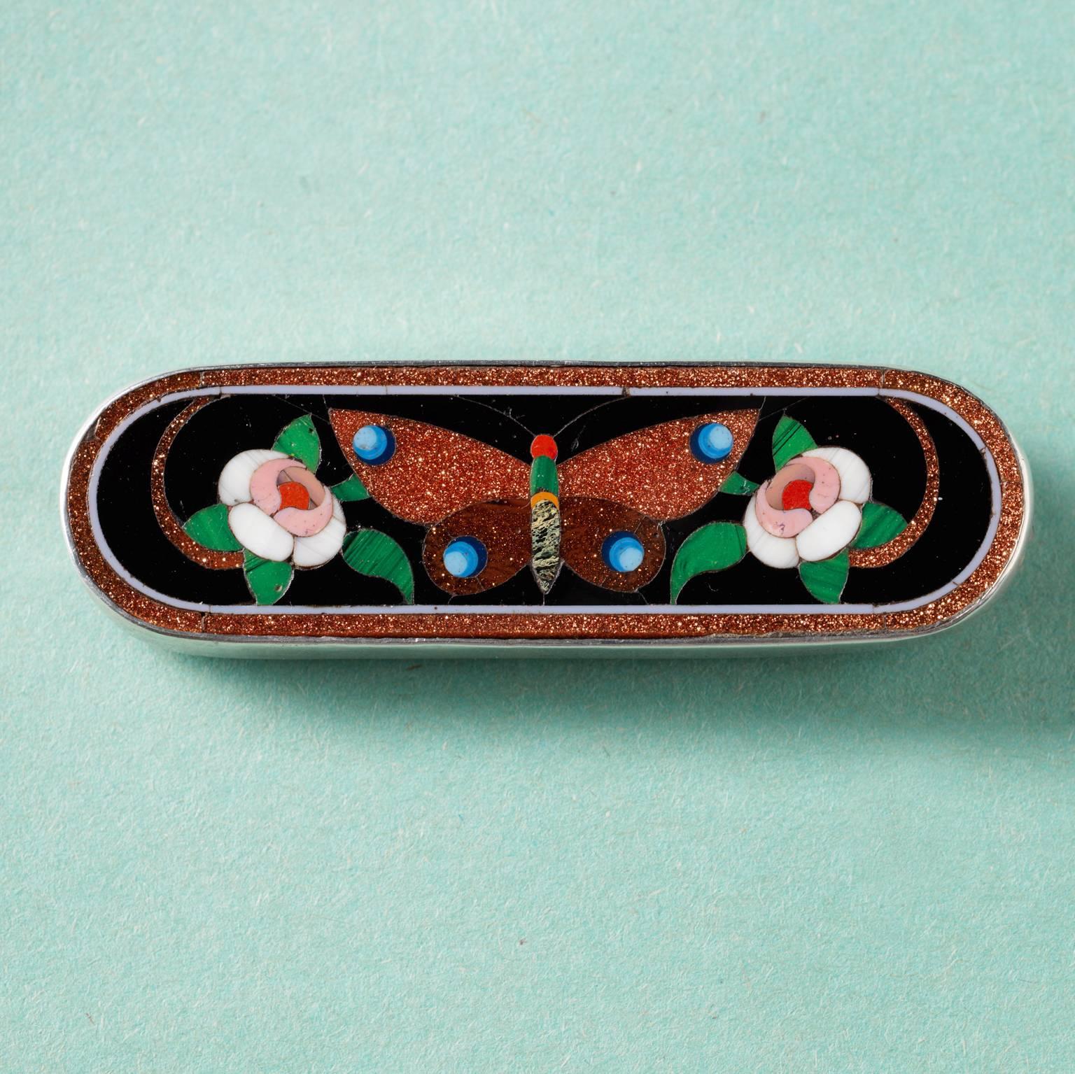 An oval silver brooch with a butterfly and flowers made of inlaid glass by Domenico Bussolin, 19th century, Italy.

weight: 14.43 grams
dimensions: 6.5 x 1.9 cm