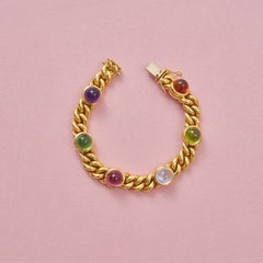 An 18k Gold Curb Link Bracelet with Gemstones