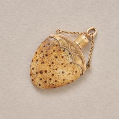 An 18k Gold Pendant with palmoxylon