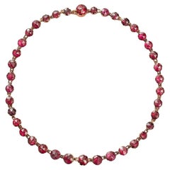 an 18k gold necklace with rose cut garnets
