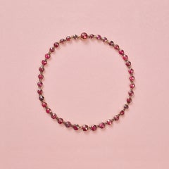 an 18k gold necklace with rose cut garnets
