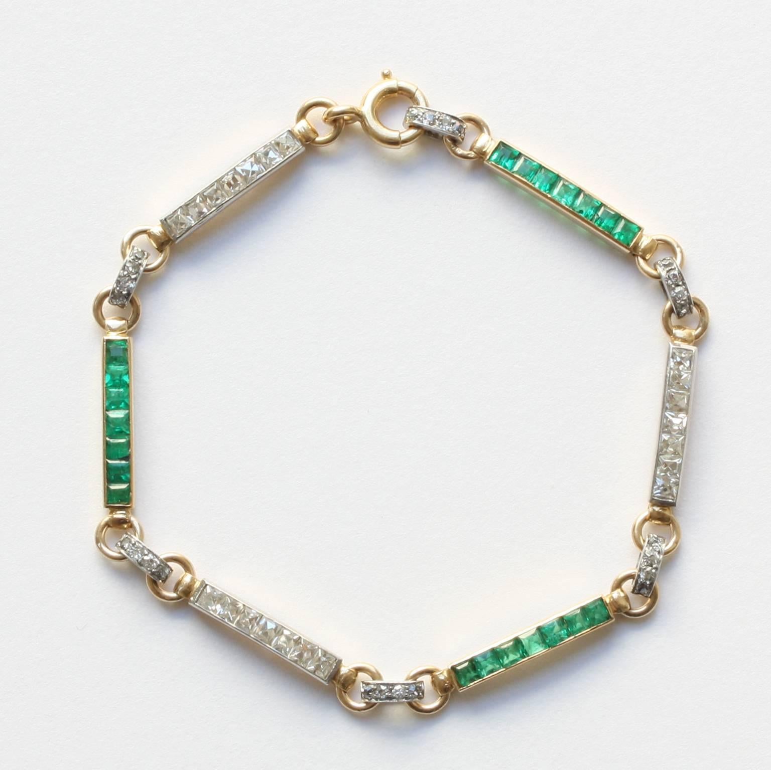 An 18 carat gold and platinum Art Deco bracelet, made out of 6 links of which 3 are set with French cut diamonds alternated with 3 links that are set with square cut emeralds, the links are divided by gold rings with a small platinum band set with