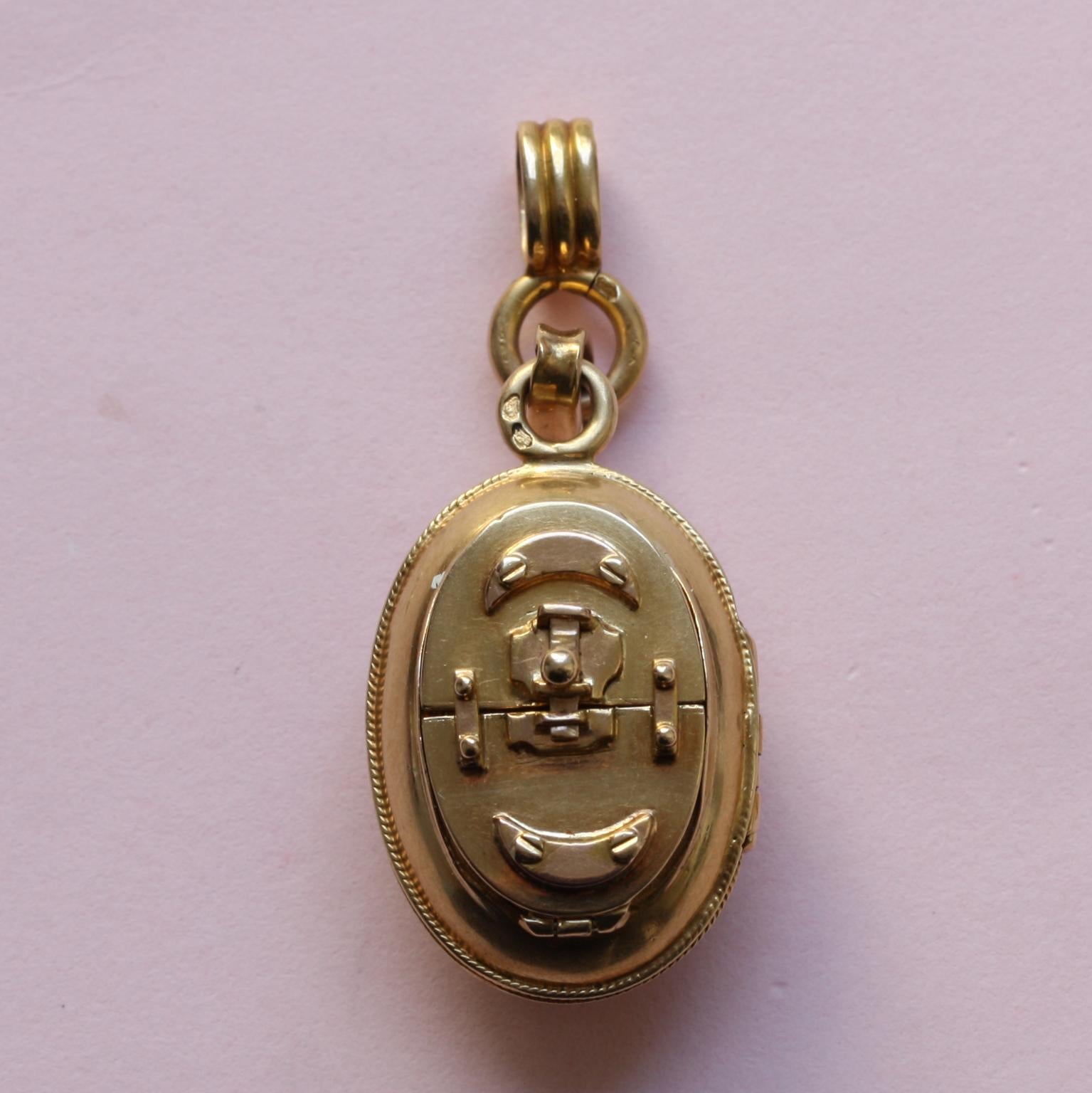 An 18 carat French locket with two compartments. One opens vertically from the middle and one opens horizontally with an actual sliding lock, each compartment has its own extra cover with glass, 19th century.

weight: 10.35 grams
size: 2.9 x 1.7 cm