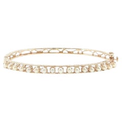 Bracciale rigido in oro giallo 14 carati con perle coltivate da 3 mm, 17 perle