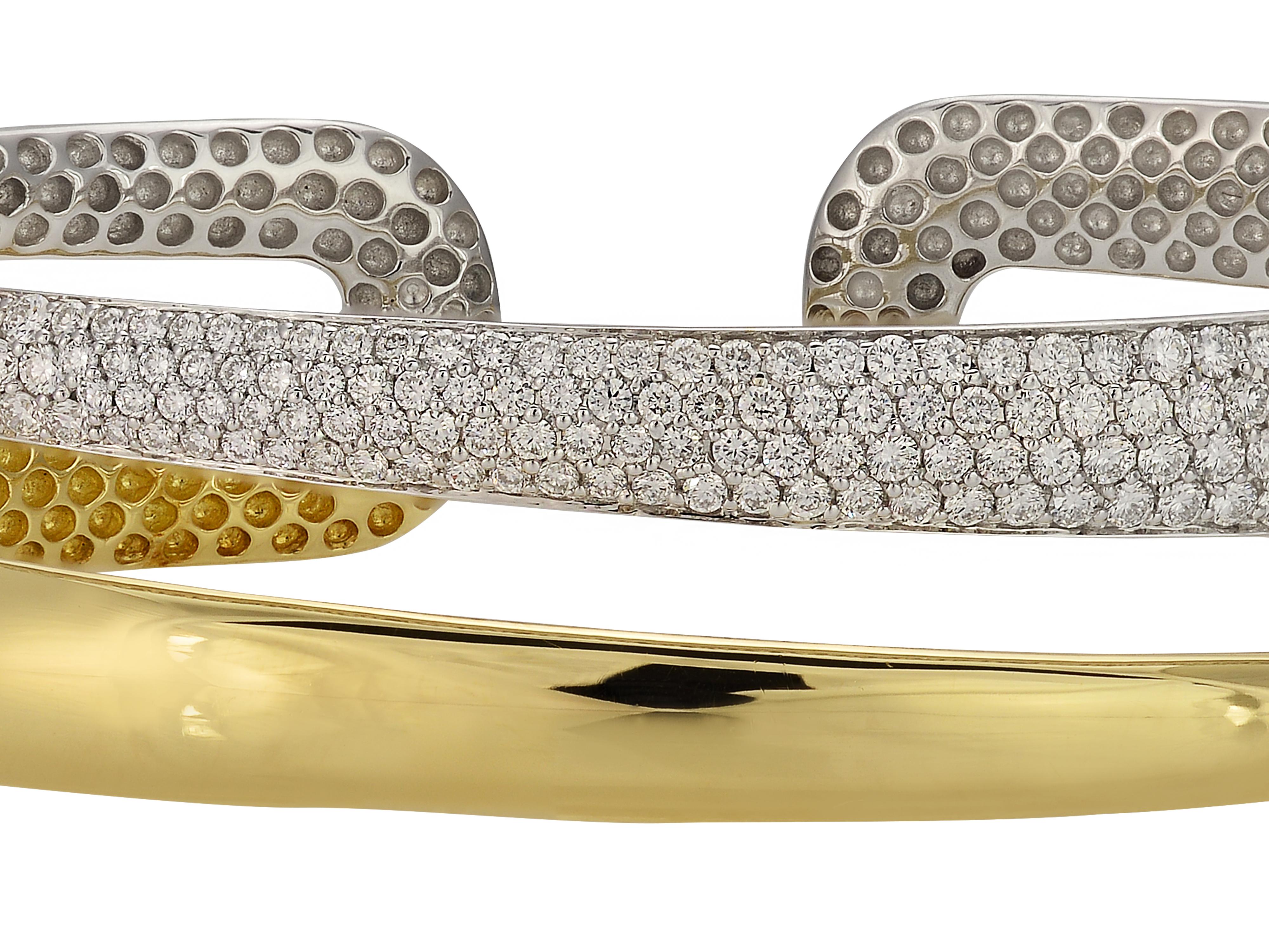 18 karat white and yellow gold hinged diamond cuff bracelet from Roberto Coin Scalare Collection. The bracelet design gives the illusion of two stacked bracelets when viewed from above. The pave set bracelet contains 1.75 carats of round brilliant