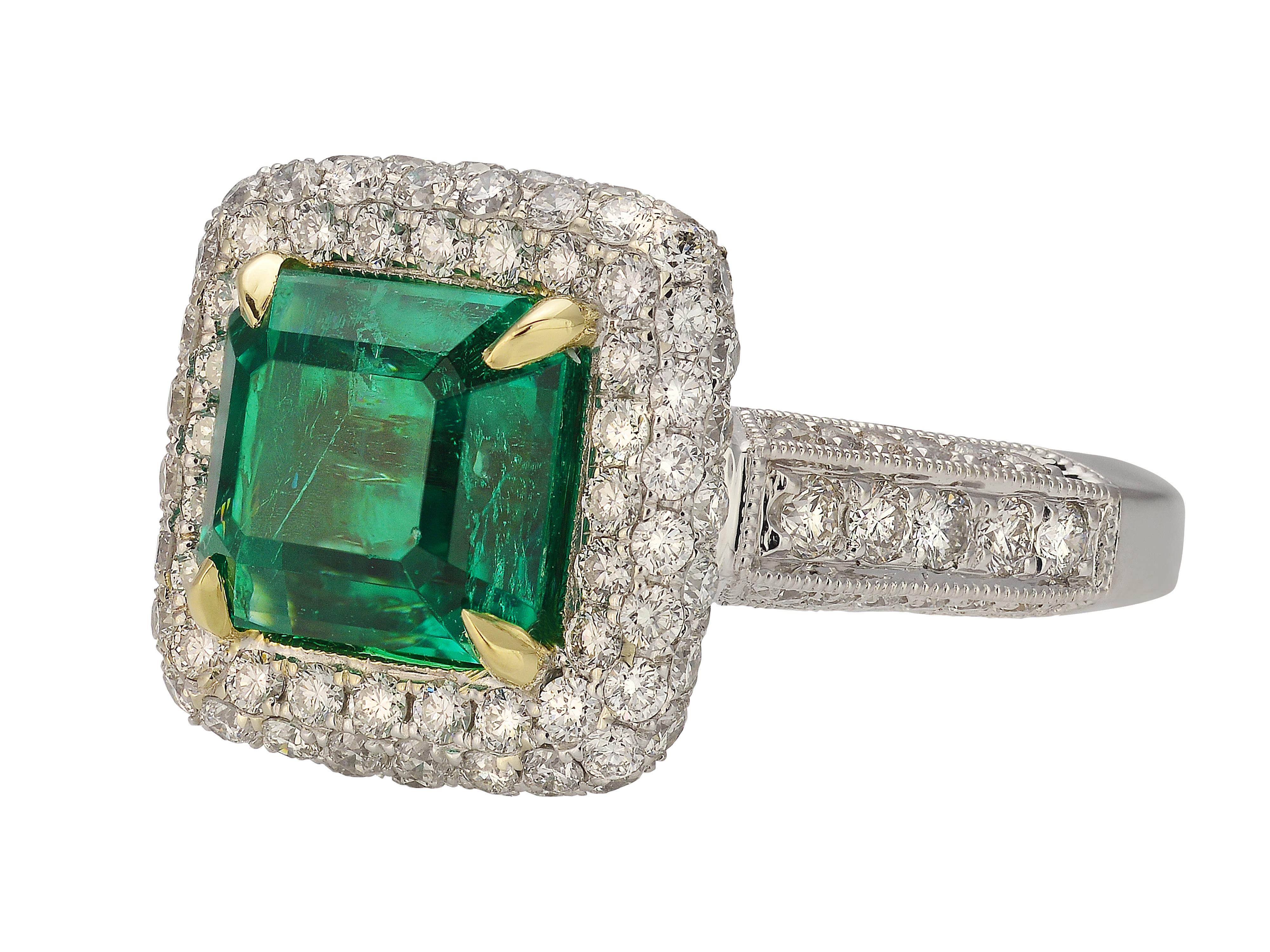 18 Karat White & Yellow Gold Emerald Ring Featuring A 3.13 Carat Octagonal Step Cut Emerald GIA Graded As Colombian In Origin. The Emerald Is Surrounded By 146 Round Brilliant Cut Diamonds Of VS Clarity & G Color Totaling 1.91 Carats. Finger Size