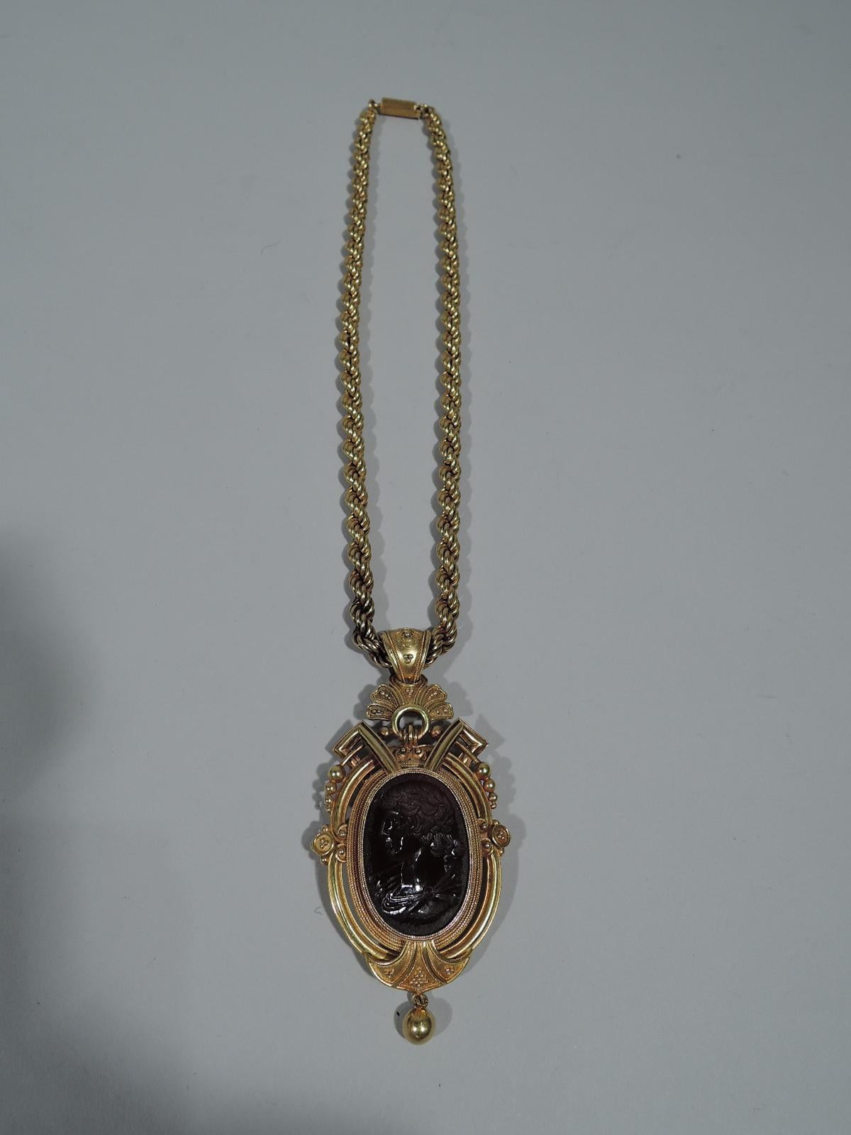 Antique 18K gold Etruscan Revival pendant with fine agate intaglio. Intaglio has beautifully carved left-facing Classical man set in fancy pendant with strapwork, rope, and beads, including drop bead. Stylized leaf has loose-mounted bail threaded