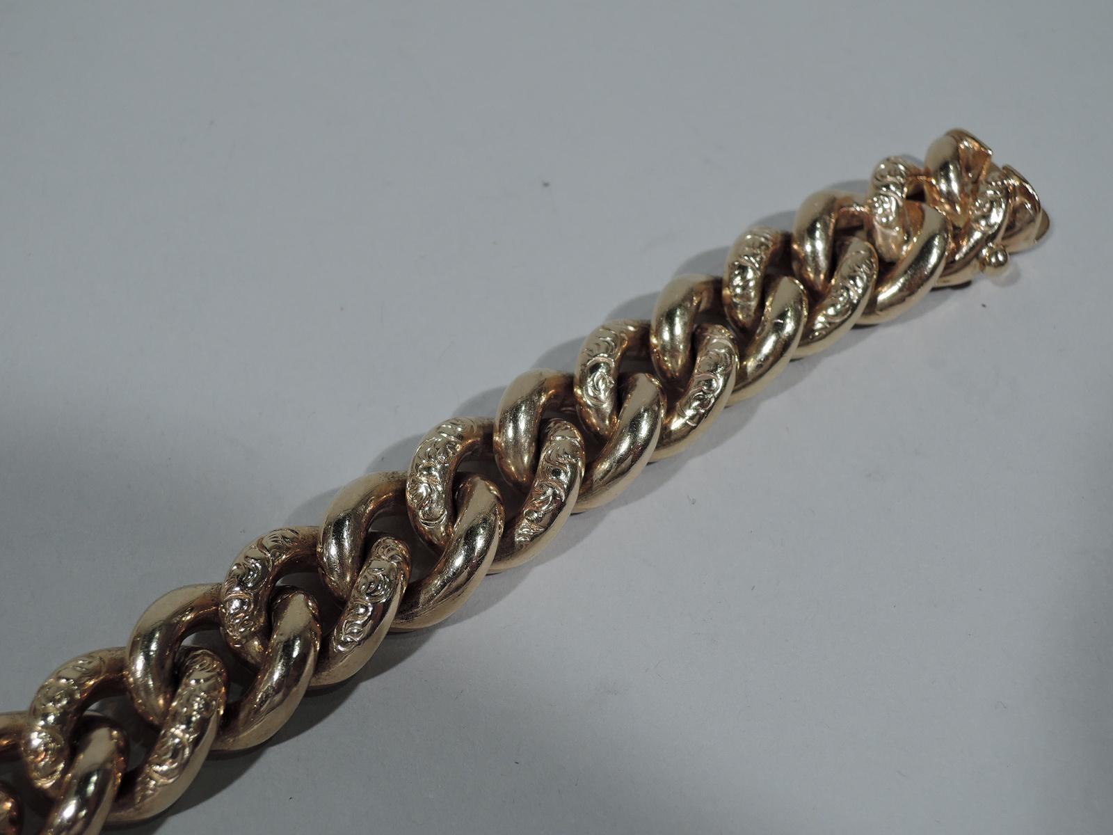 Edwardian 10k gold chain bracelet comprising alternating plain and ornamented links. The ornamented links have tooled scrollwork. England, ca 1910. Marked. Heavy weight.