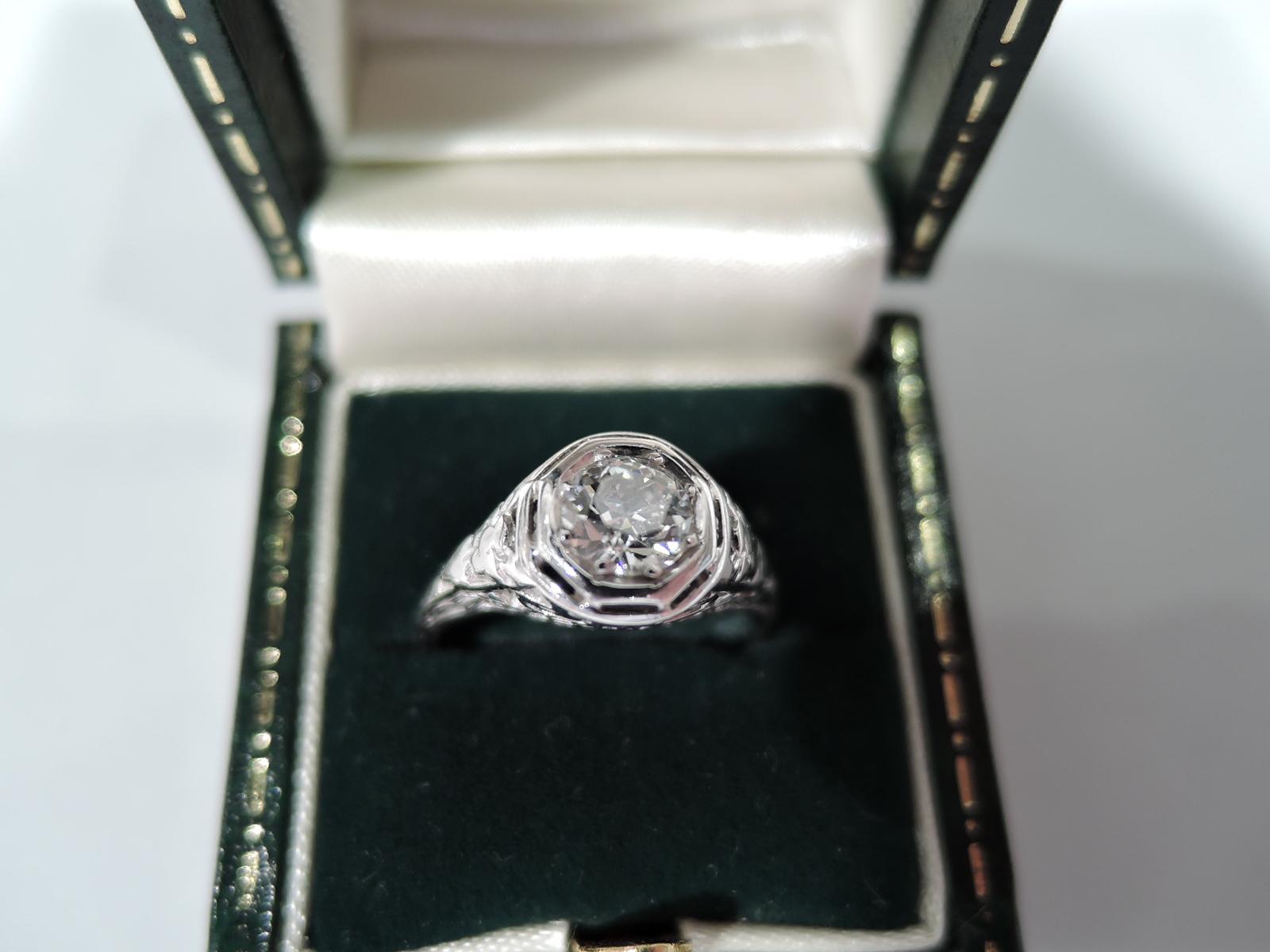 Lovely Edwardian platinum and diamond (approx. 0.58 carat) solitaire ring with pierced ornament. United States, ca 1910.  Size 7.