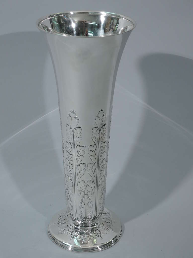 Large sterling silver vase. Made by Tiffany in New York, ca. 1912. Tapering sides with flared rim, and raised circular foot. Repousse acanthus leaves rise from the base. Repousse scrolls and foliage encircle foot. The pattern (no. 18190B) was first