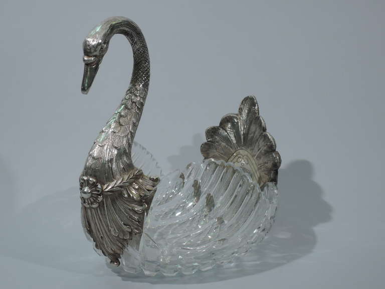 Cut glass and 800 silver centerpiece bowl in form of swan. Made in Germany, ca. 1900. Bowl is clear glass with cut and engraved feathered wings. To front is mounted silver breast , neck, and head. To back is mounted tail. Fine delineation of the