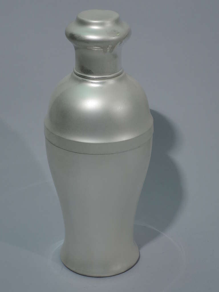 Large sterling silver martini shaker. Made by Howard & Co. in New York, ca. 1920. Fluid baluster form. Cover is cylindrical with bulbous top. Built in strainer. A functional design evocative of modern sculpture. Hallmark includes model no. 2238.
