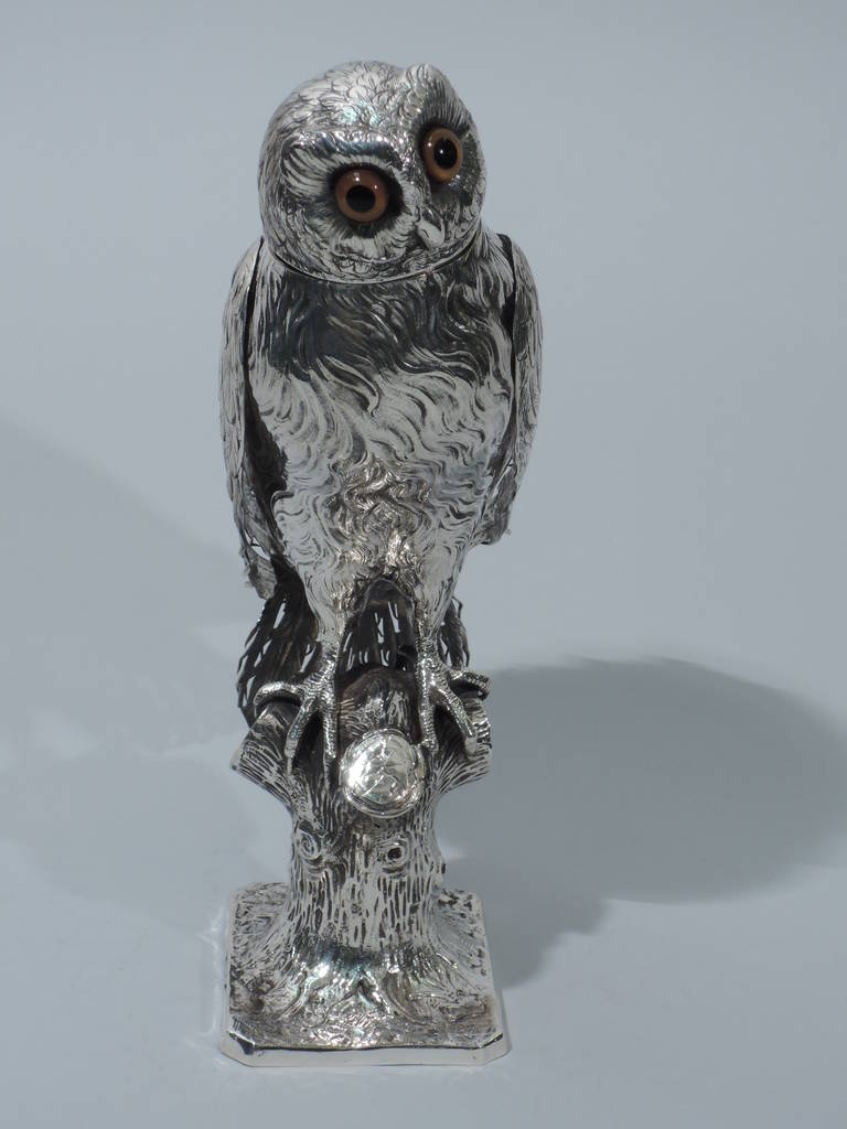 German 800 silver spice box in form of owl, ca. 1900. The bird grips with sharp talons a knobby tree trunk. Coarse feathering to body and hinged wings. Detachable head with expressive face. Brown and black glass eyes. Hallmarked. Excellent condition