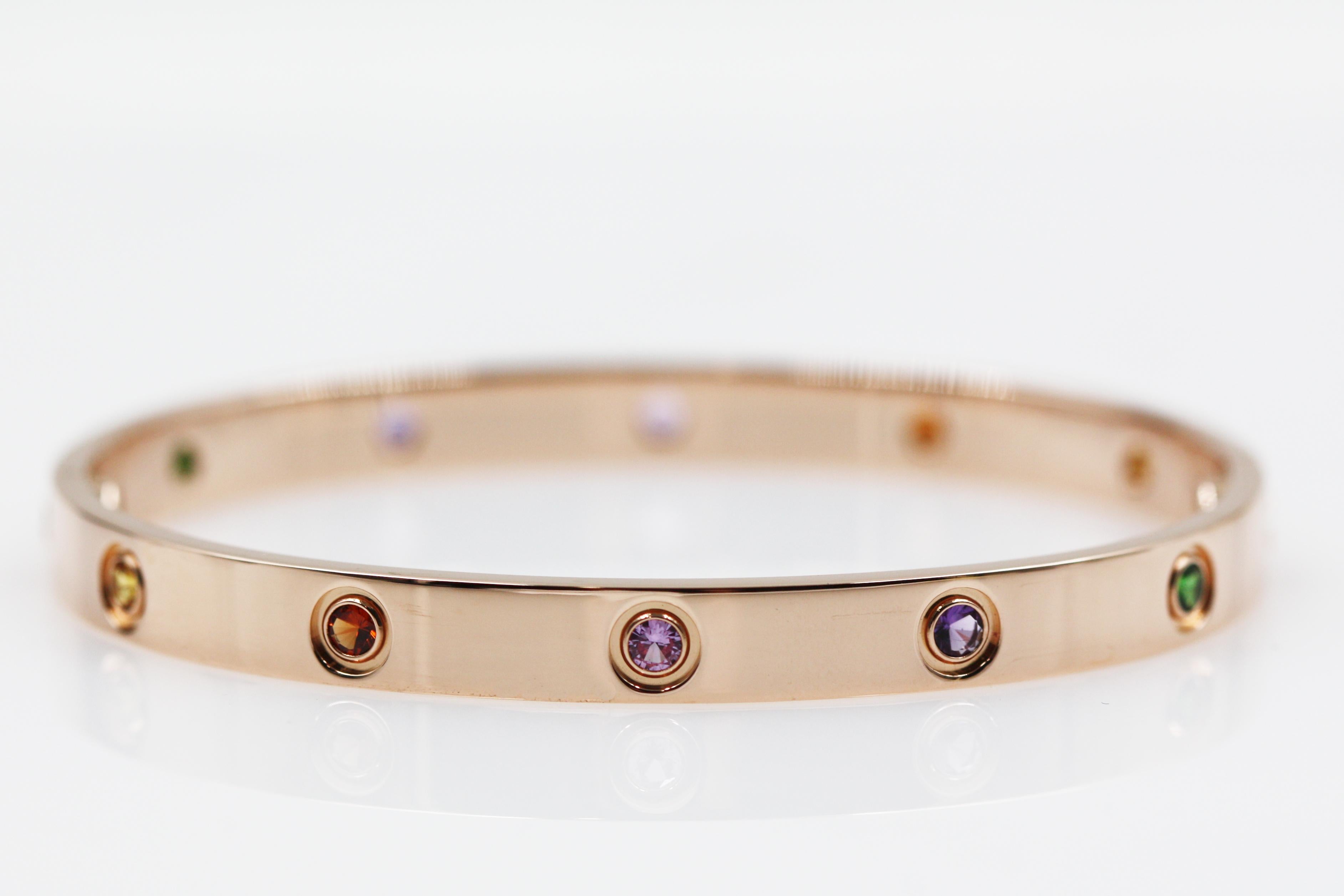 A Beautiful bracelet from Cartier Love collection, made in 18K rose gold, set with 2 pink sapphires, 2 yellow sapphires, 2 green garnets, 2 orange garnets and 2 amethysts. 

Size 19
This item will come with an original box and warranty
We have other