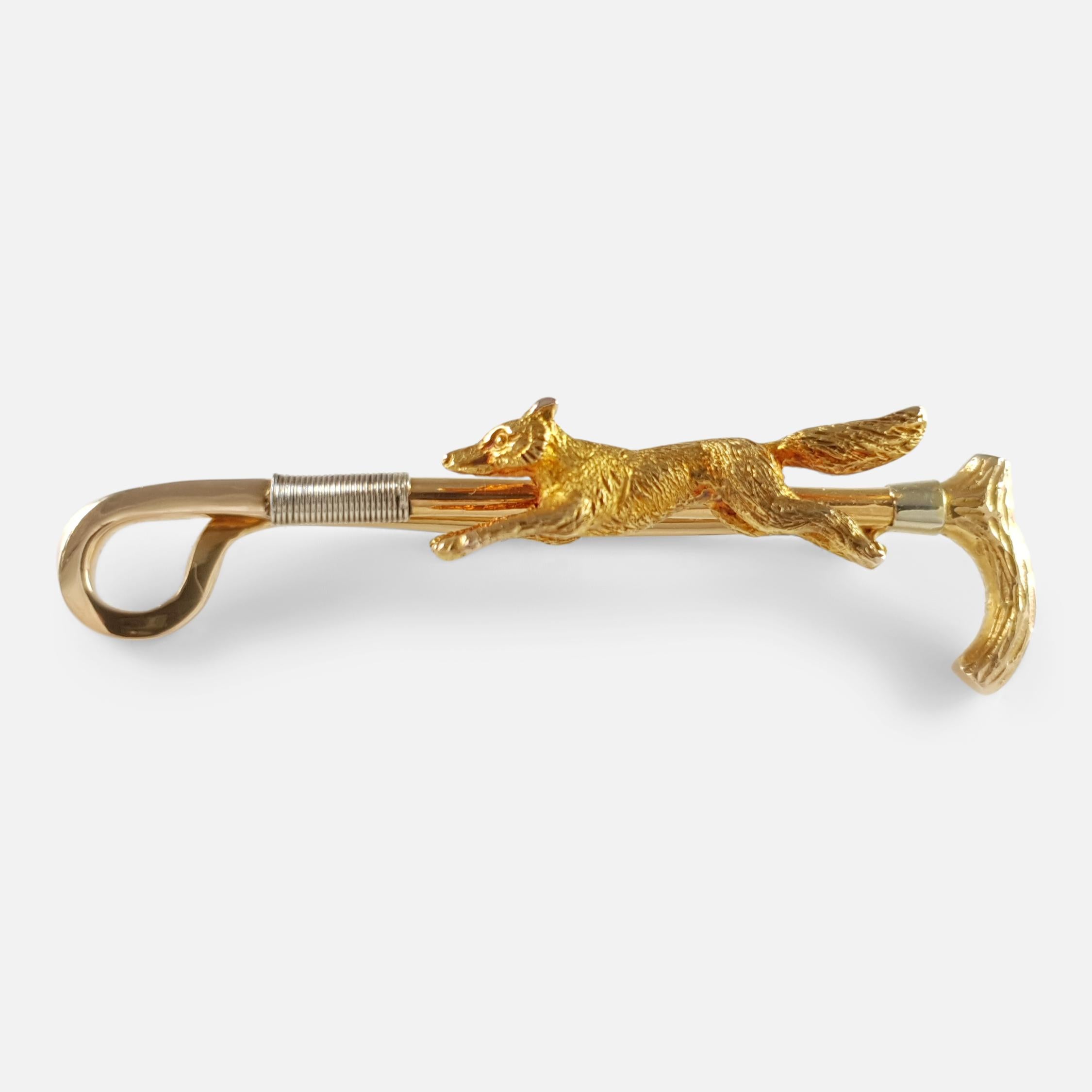 Description: - This is a beautiful 15 karat gold fox hunting brooch stock pin.  The brooch is crafted in the form of a fox in full flight with a riding crop in the background. The brooch is stamped 