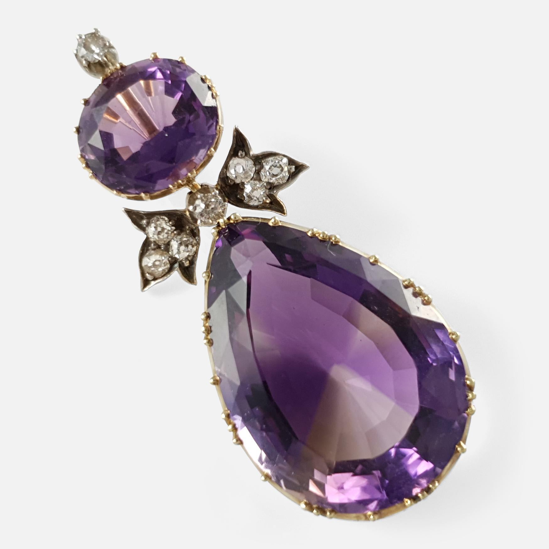 Description: - This is a stunning antique 15 karat yellow gold amethyst and diamond drop pendant. The pendant is fronted by an old round cut diamond above a horizontally set oval cut amethyst, that suspends a pair of ivy leaves set with a further