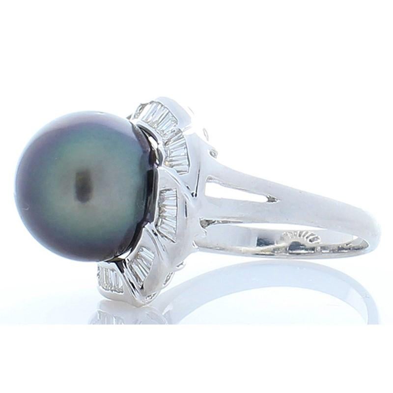 This luxurious Tahitian black pearl and diamond ring is huge on style and sophistication.  A lustrous and illuminating 11.9 millimeter black pearl that is bursting with undertones of eggplant and black sand. The black pearl lights up even more