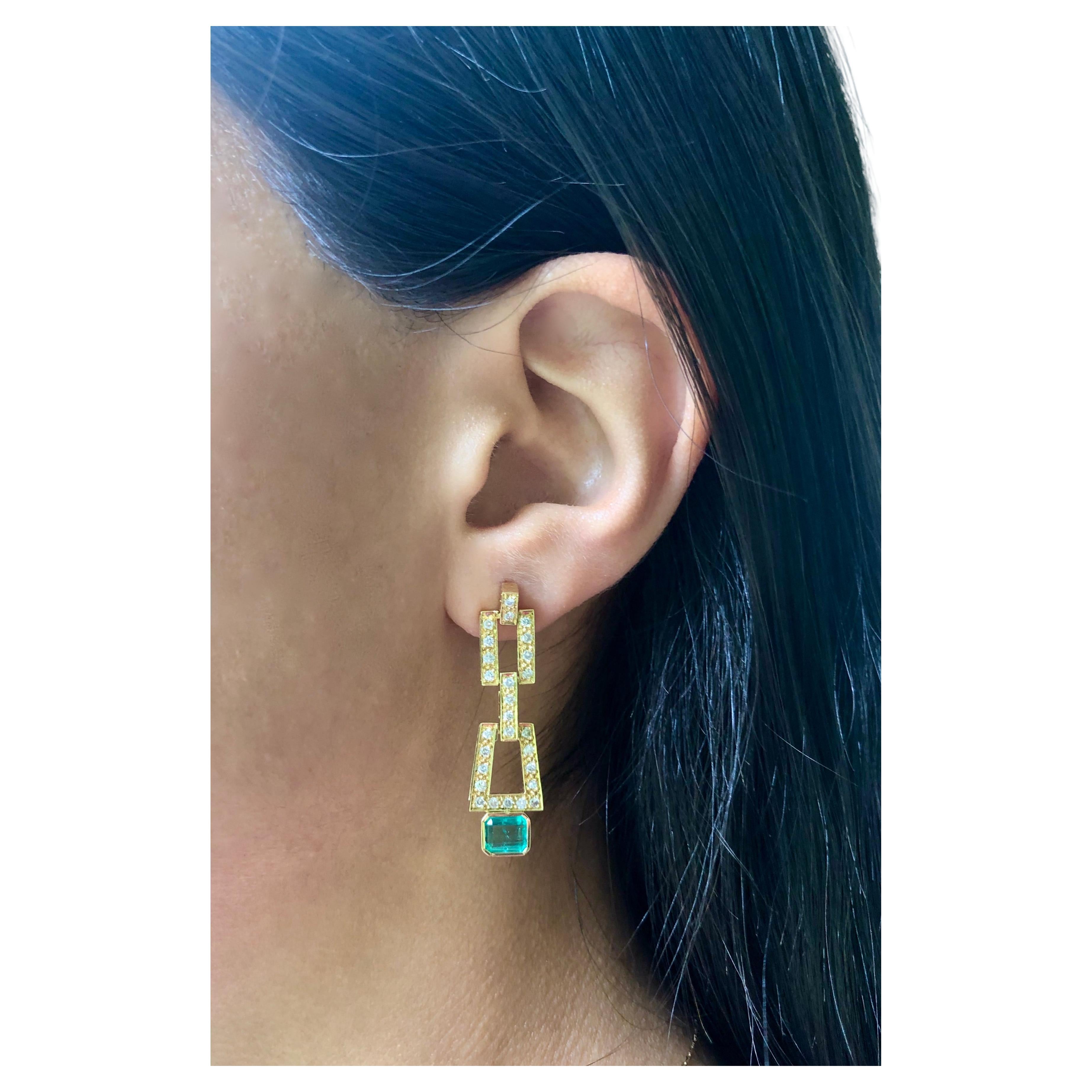 Sophisticated dangle drop earrings! Doesn't need much when you have a gorgeous Colombian emerald paired with white diamonds. These classic and timeless earrings have 1.80 carat natural emerald cut Colombian emerald medium green color, VS in clarity,