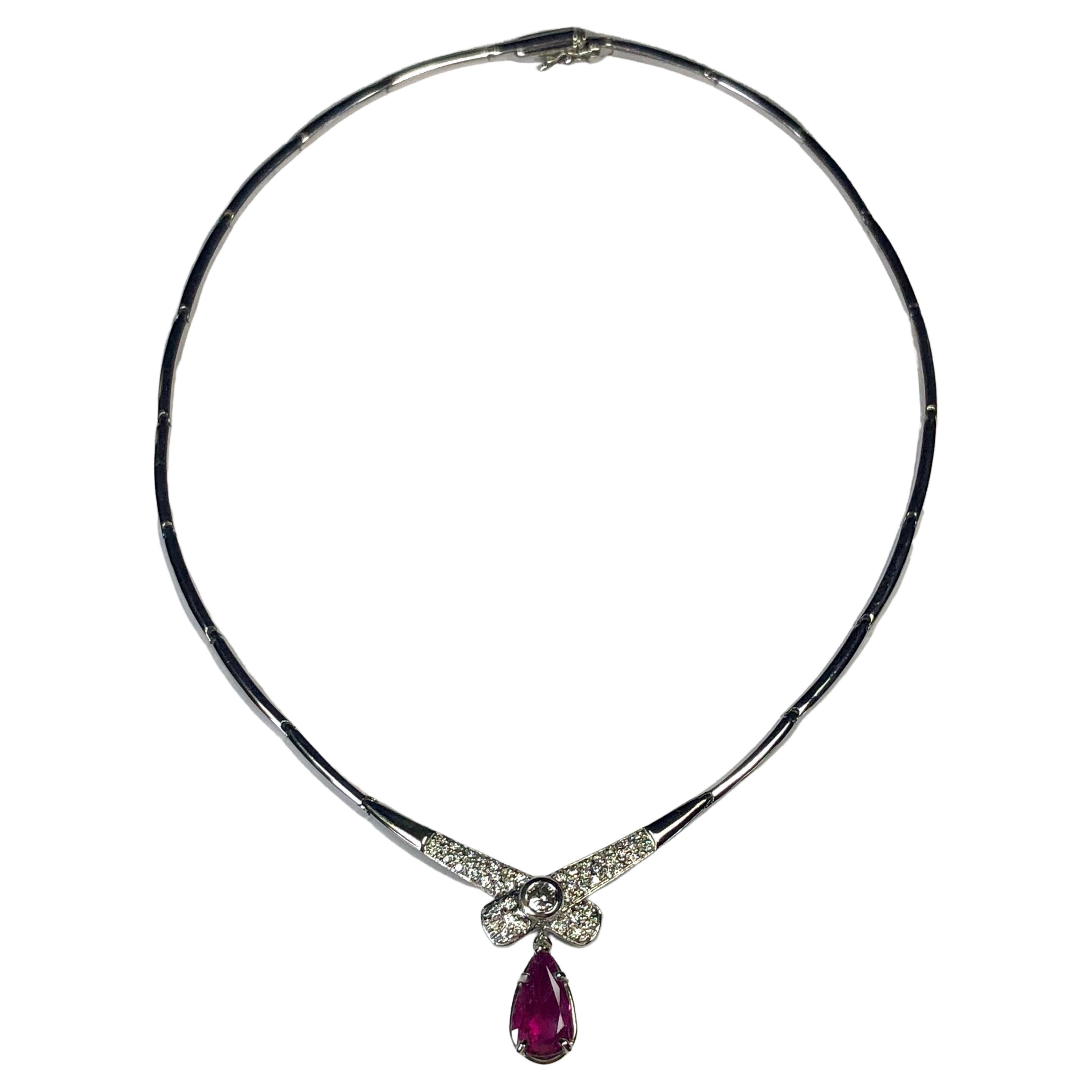 ESTATE Necklace Featuring in the Center a Pear Cut Mozambique Natural Ruby Weighing 2.30 carats, Not Treated. The ruby is set in a beautiful vintage-inspired scroll setting. The center bow design of the necklace features a round brilliant cut