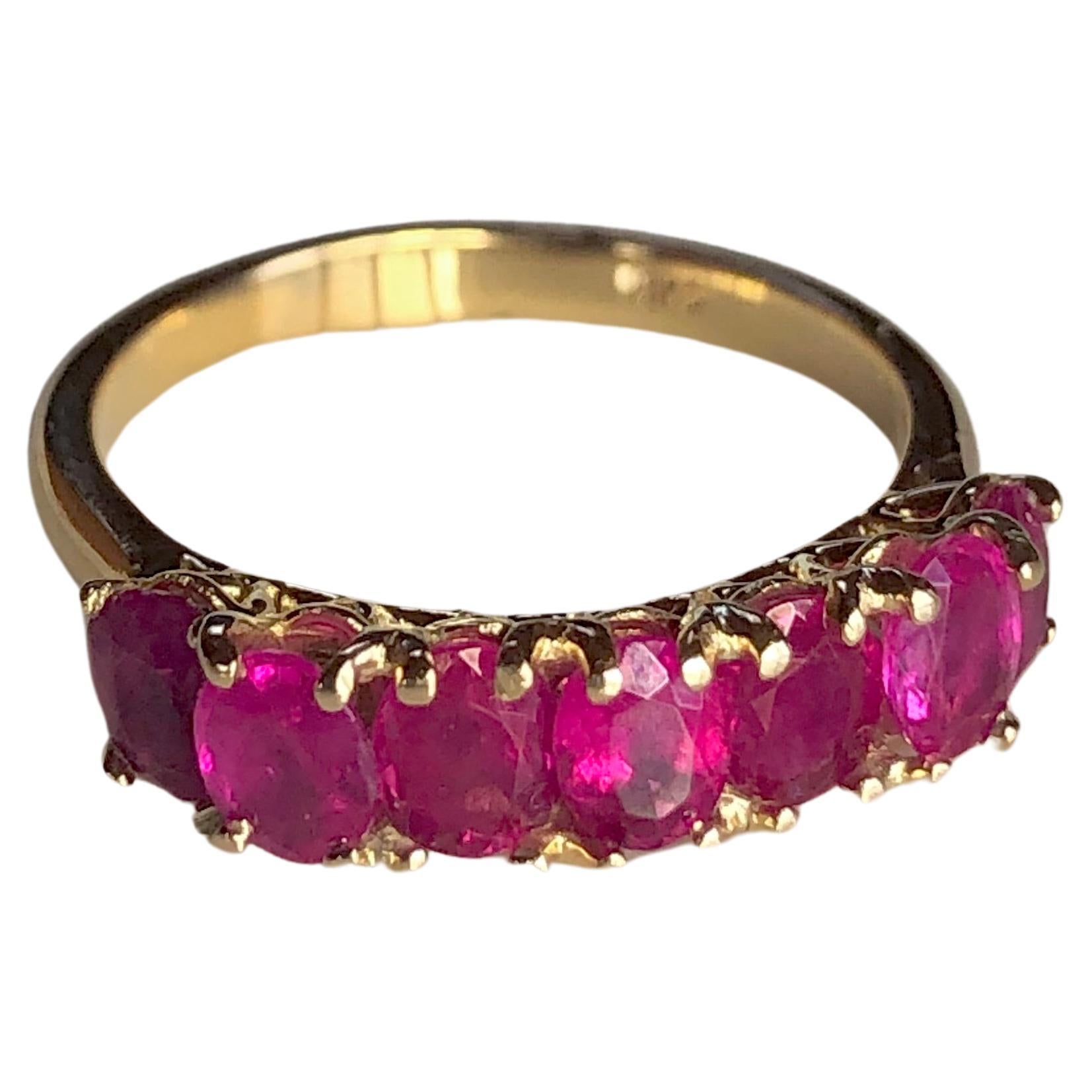 An estate vibrant pinkish red oval-cut natural Burmese ruby seven-stone ring., weighing Approx. 2.30 carats, set in a very classic seven-stone 18K yellow gold mounting. The oval-cut rubies are full of color and brilliance. Stunning.  
Condition: