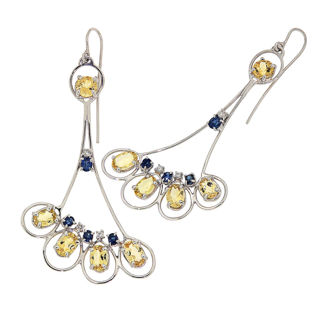 Reflecting the peacocks stunning colouring and graceful movement, these earrings display a yellow, blue and silver colour combination, handmade in 18 karat white gold these earrings are characterized by diamonds weighing 0.35 ctw, blue sapphires