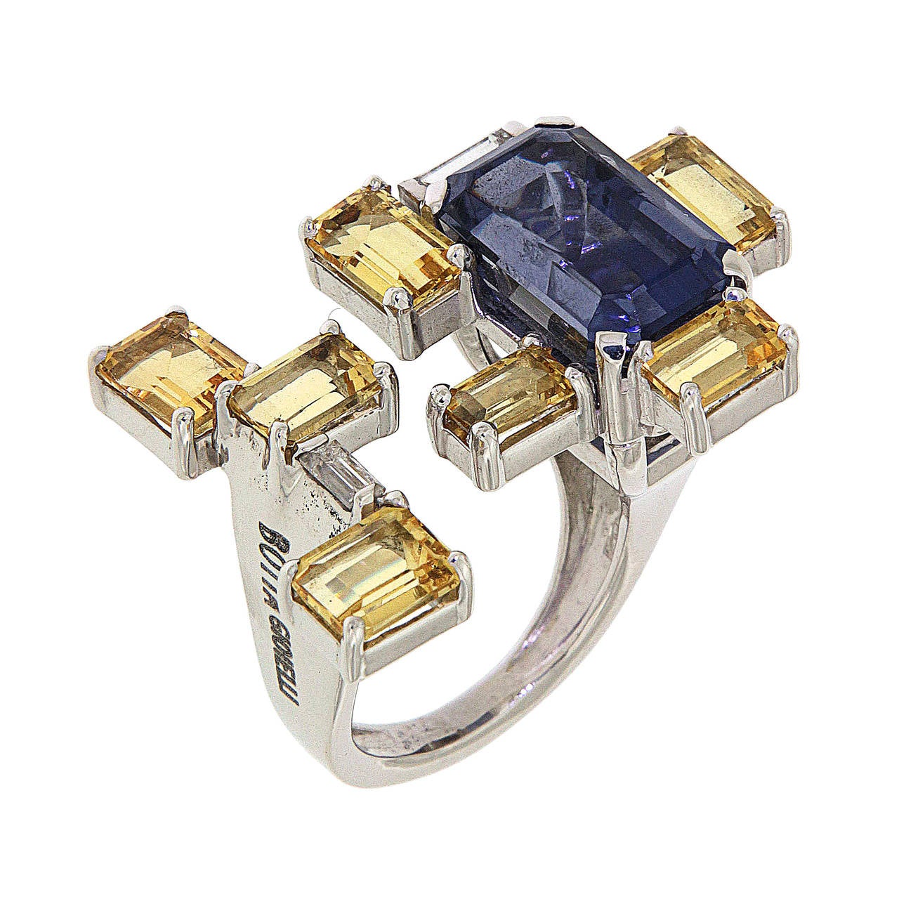 A geometric ring set in 18 carat White Gold with an intense 7.20 carat blue  Iolite, 5.30 carat Yellow Beryls and 0.40 carat Diamonds
The Finger Size is 7, can be resized.