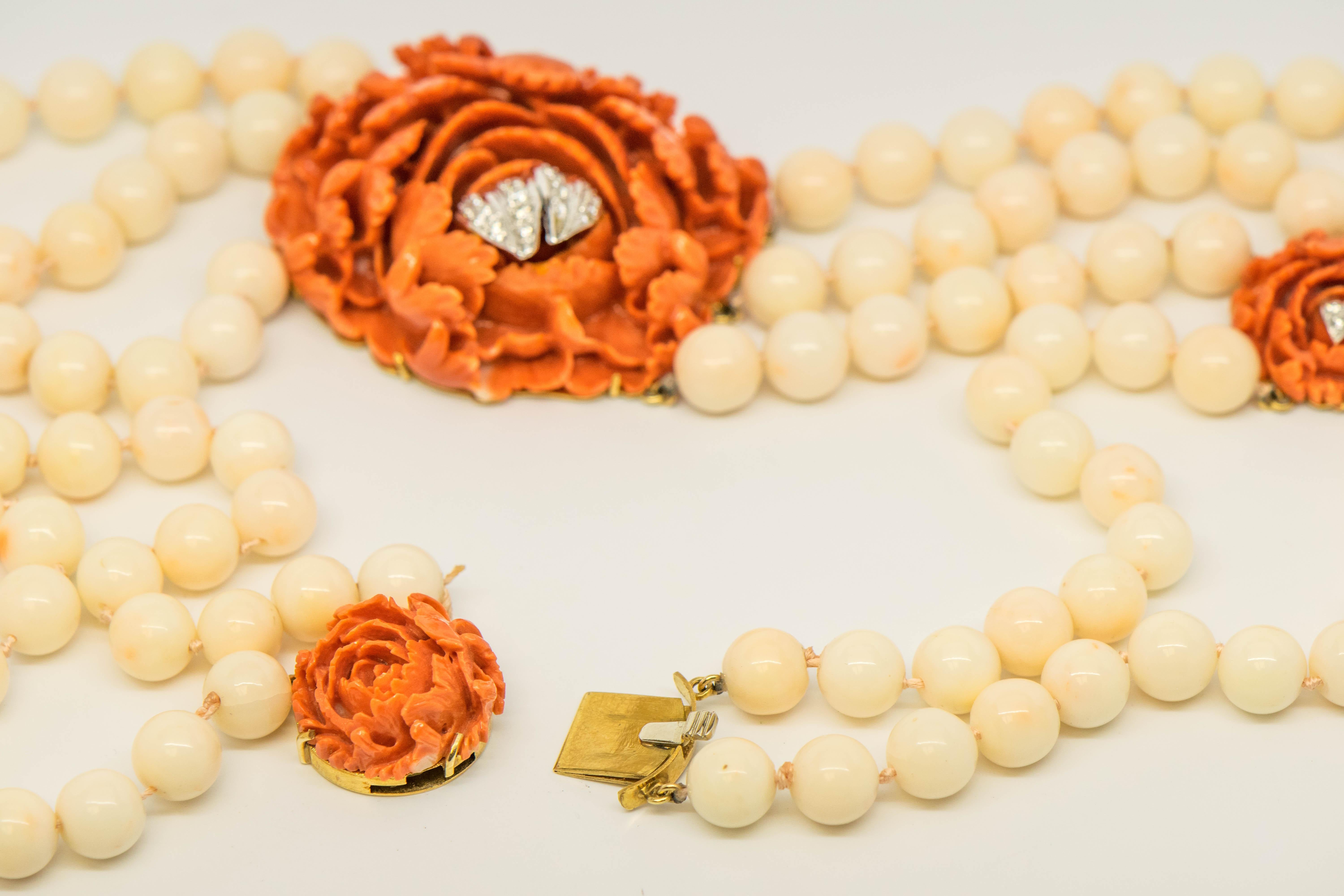 This is a magnificent Diamond and Coral Multi-Strand Necklace that is so artistically designed, you must see the photographs!  Placed in gracefully carved Coral Flower Rosettes are (28) Round Brilliant Cut Diamonds, G-H in Color, VS in Clarity for