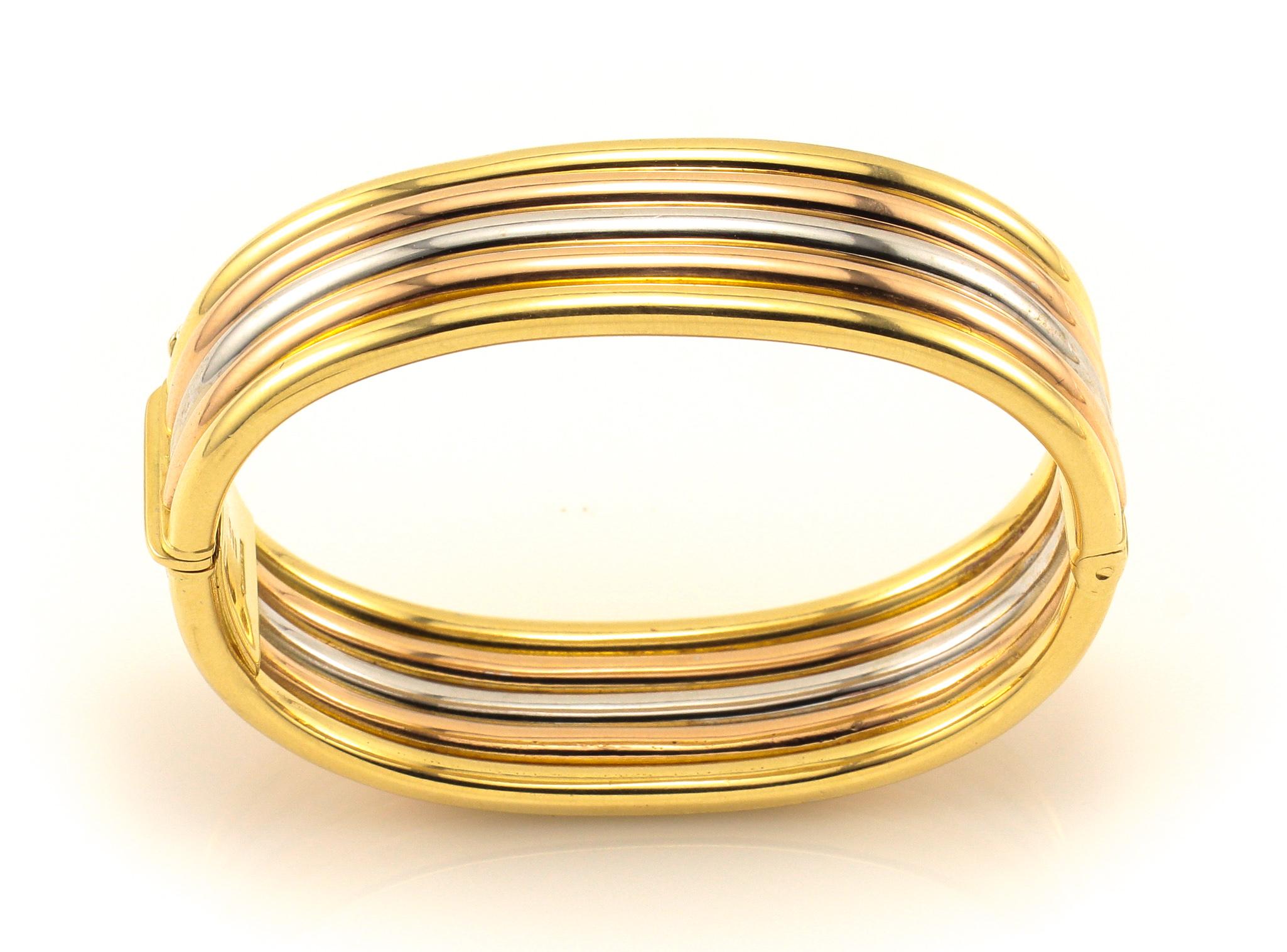 This is an alluring 18K Gold Bangle Bracelet. So unusual in it's design with 5 Rows of 18K Yellow, Rose and White Gold fabricated in a comfortable oval bangle that is almost 3/4 of an inch in width. The Bracelet is hinged for ease in wearing and is