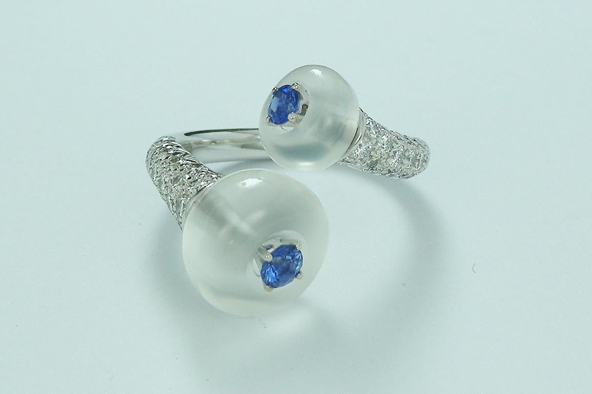 A chic and Unique De Falbert Toi et Moi Ring, crafted in 18 Karat White Gold (5.41 Grams) .

Ring Details :

2 blue moonstones ( 9 Total Carat Weigh ) , 
2 blue Sapphires ( 0.36 Total Carat Weigh )
43 Diamonds ( 0.95 Total Carat Weigh ) - F color -
