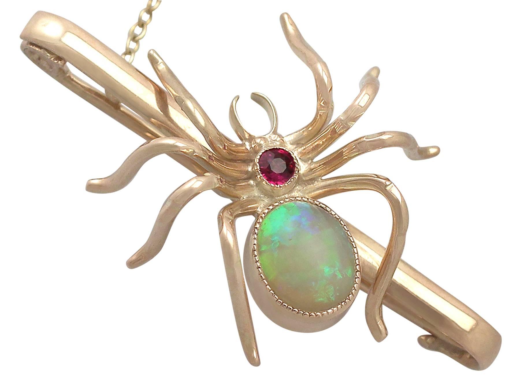 A fine and impressive antique 1.22 carat opal and 0.10 carat natural ruby, 9 karat yellow gold bar brooch in the form of a spider; part of our antique jewelry and estate jewelry collections

This fine and impressive bar brooch has been crafted in