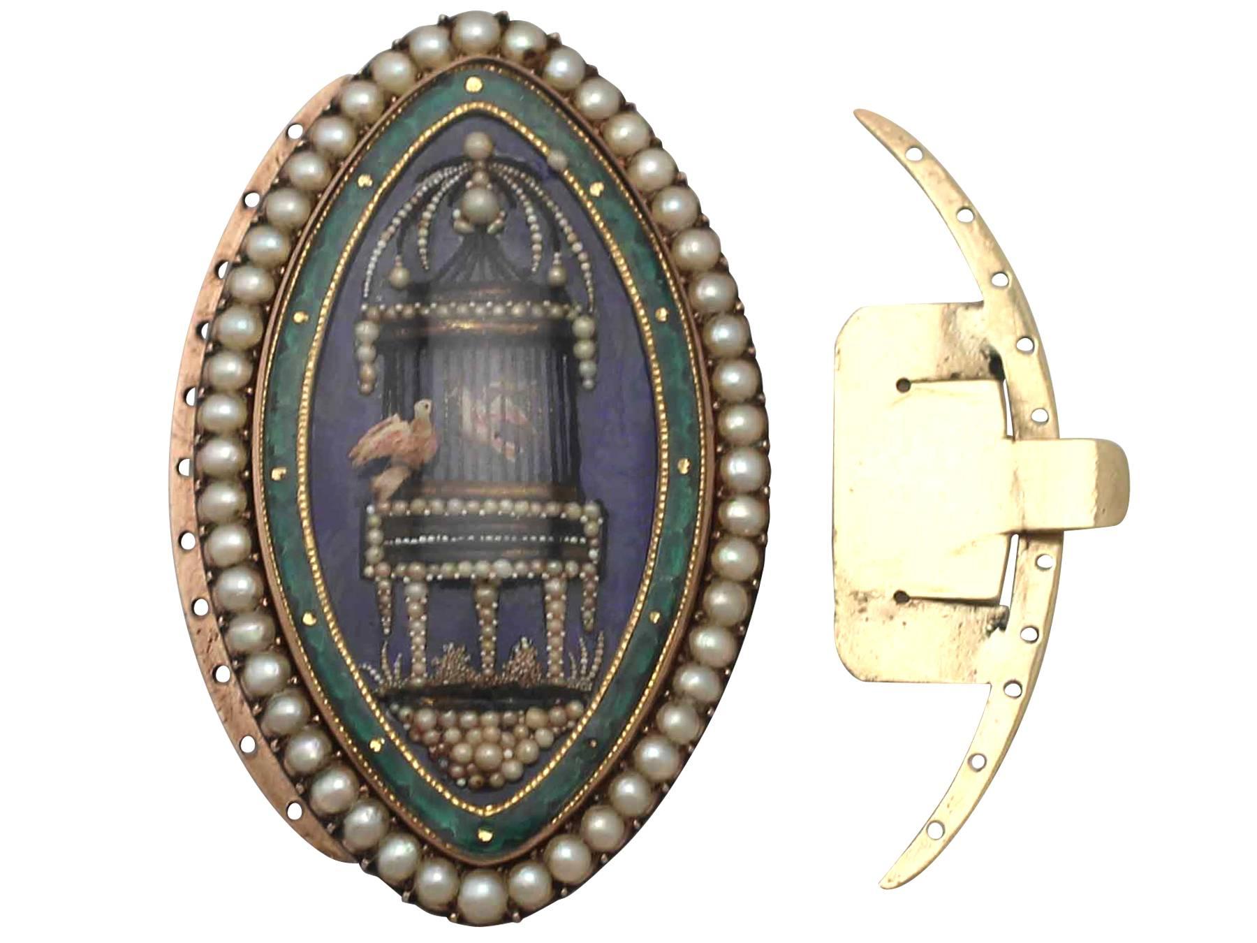 This exceptional, fine and impressive pearl necklace clasp has been crafted in 10k yellow gold and enamel.

The elliptical, subtly convex clasp displays a feature hand painted miniature enamel plaque depicting an ornate bird cage holding one bird,