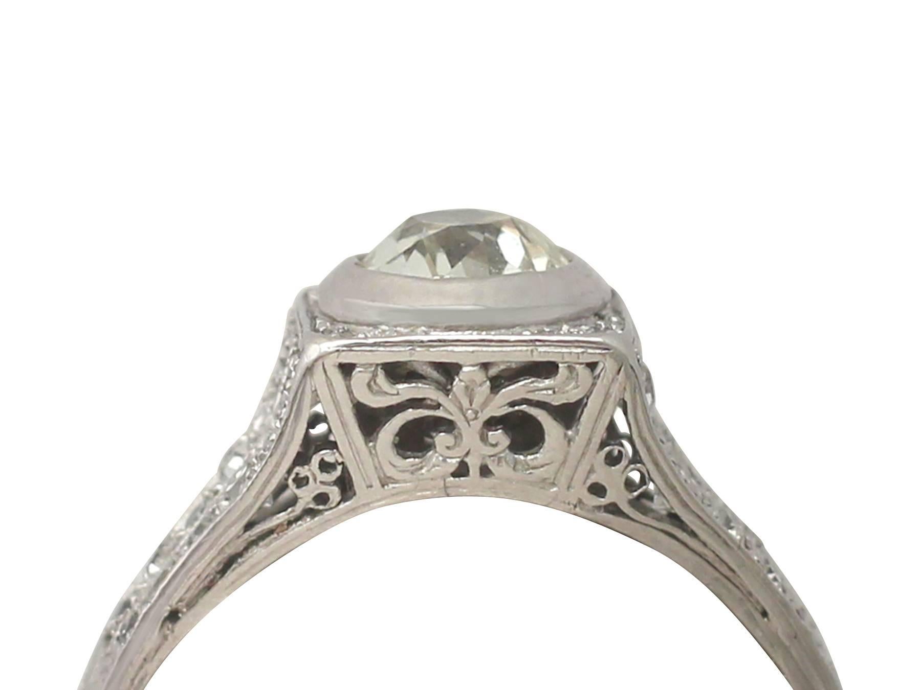This stunning, fine and impressive diamonds has been crafted in platinum.

The ring has a pierced decorated, square shaped setting embellished with millegrain and bead decoration.

The ring displays a feature 0.85 ct Old European round cut diamond