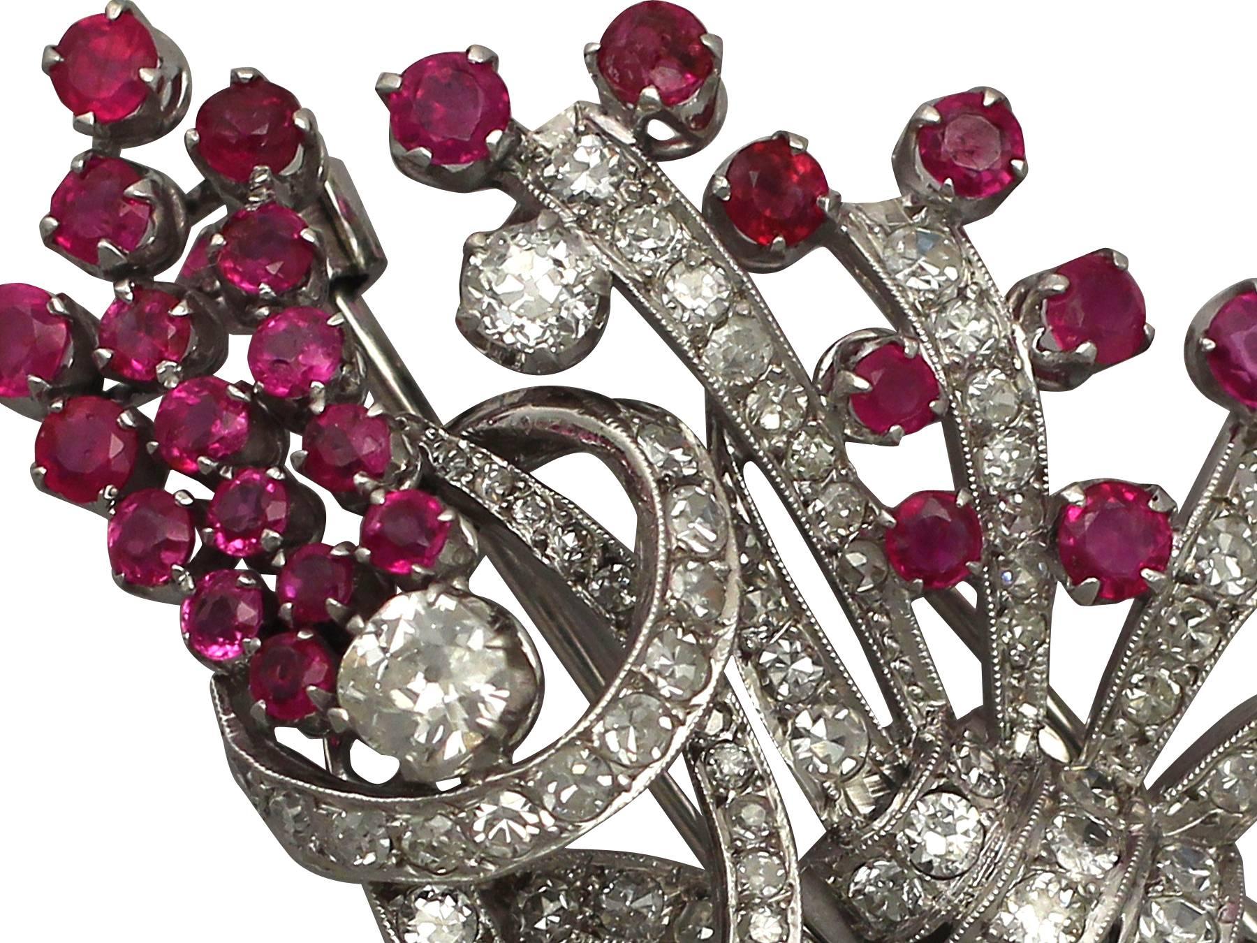 This stunning, fine and impressive antique diamond and ruby double clip brooch has been crafted in platinum.

The brooch has been modelled in the form of a floral bouquet tied with scrolling ribbons.

The flower sprays are ornamented with a