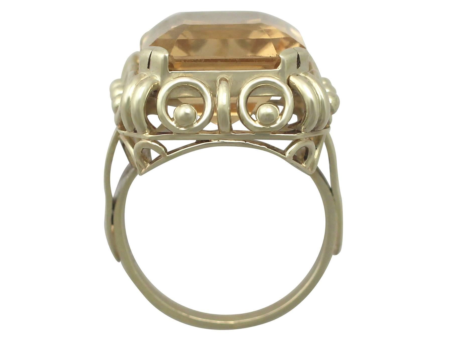 This fine and impressive large citrine ring has been crafted in 14k yellow gold.

The substantial, pierced decorated ring shank displays a feature 14.18 ct step cut citrine, four claw / prong set in relief.

The setting has a ring and ball