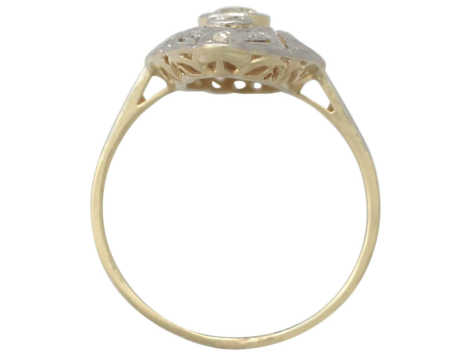This fine and impressive antique Art Deco diamond ring has been crafted in 14k yellow gold with a 14k white gold setting.

The pierced decorated marquise shaped frame is ornamented with a feature 0.24 ct Old European round cut diamond flanked to the