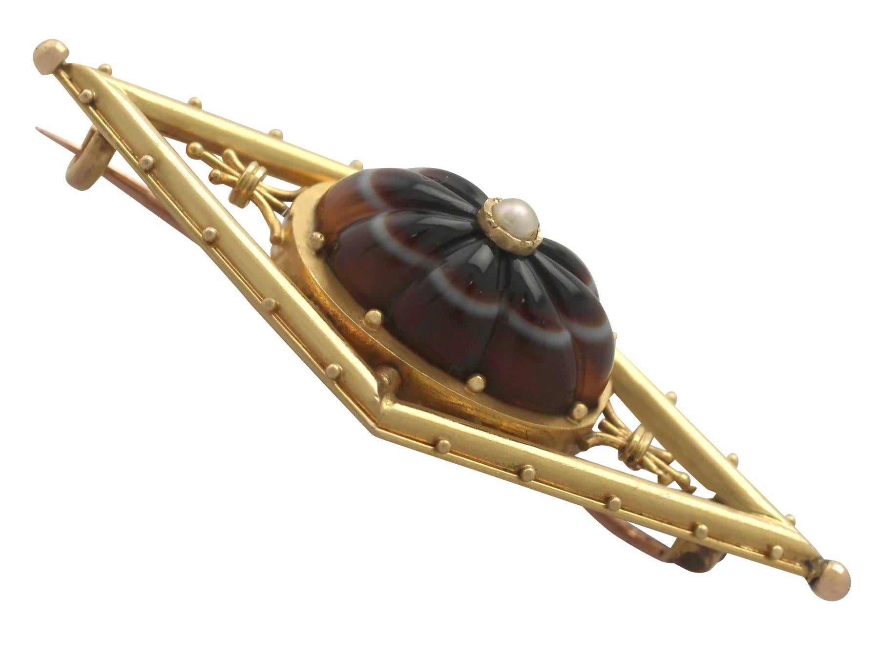 A fine and impressive agate and seed pearl, 15 karat yellow gold and 9 karat rose gold brooch; part of our diverse antique jewelry and estate jewelry collections

This fine and impressive Victorian agate brooch has been crafted in 15 k yellow gold