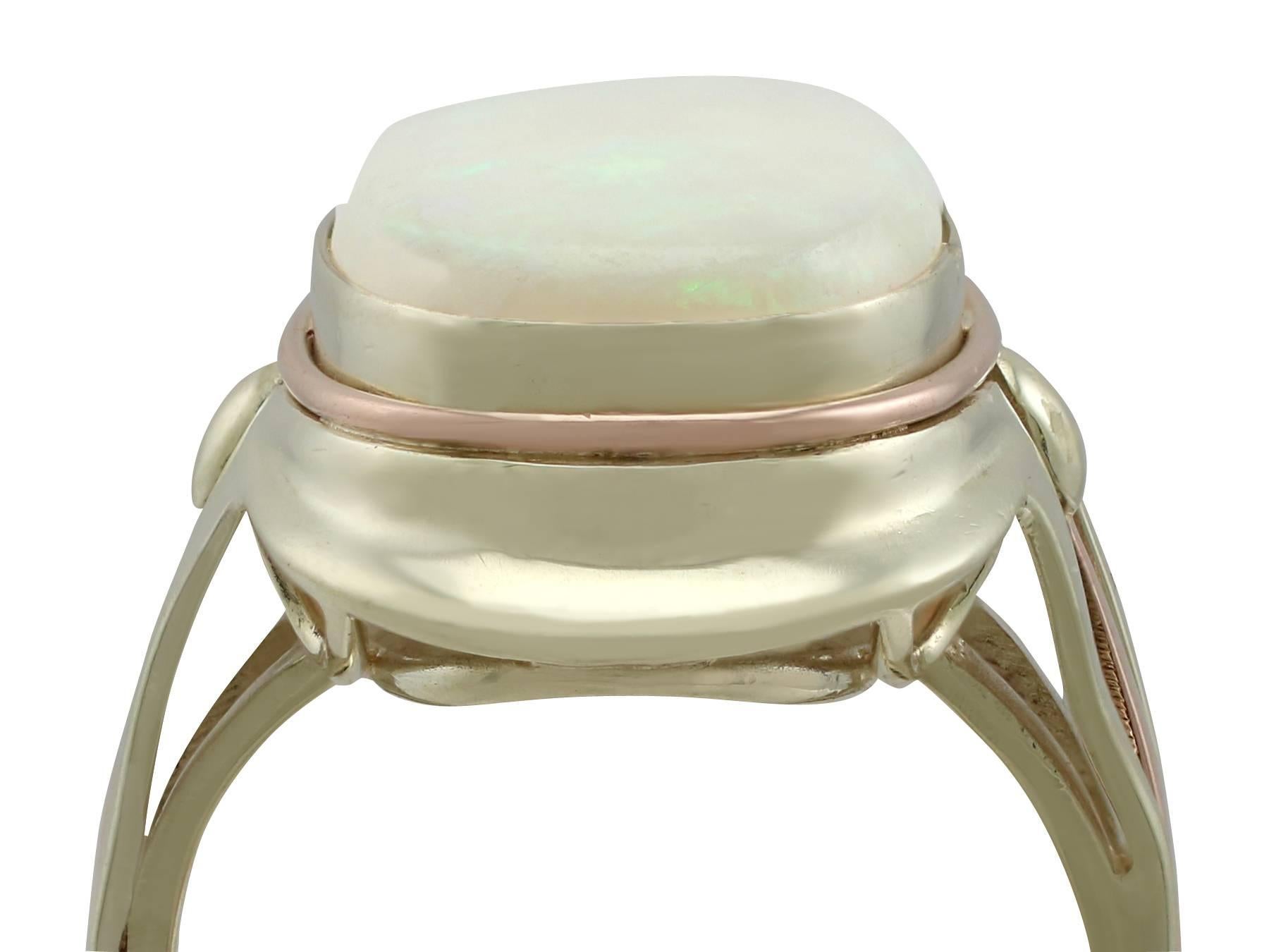 An impressive 6.91 carat white opal and 14 karat yellow gold, 14 karat rose gold cocktail ring; part of our diverse vintage jewelry and estate jewelry collections

This fine and impressive large oval opal ring has been crafted in 14k yellow and rose