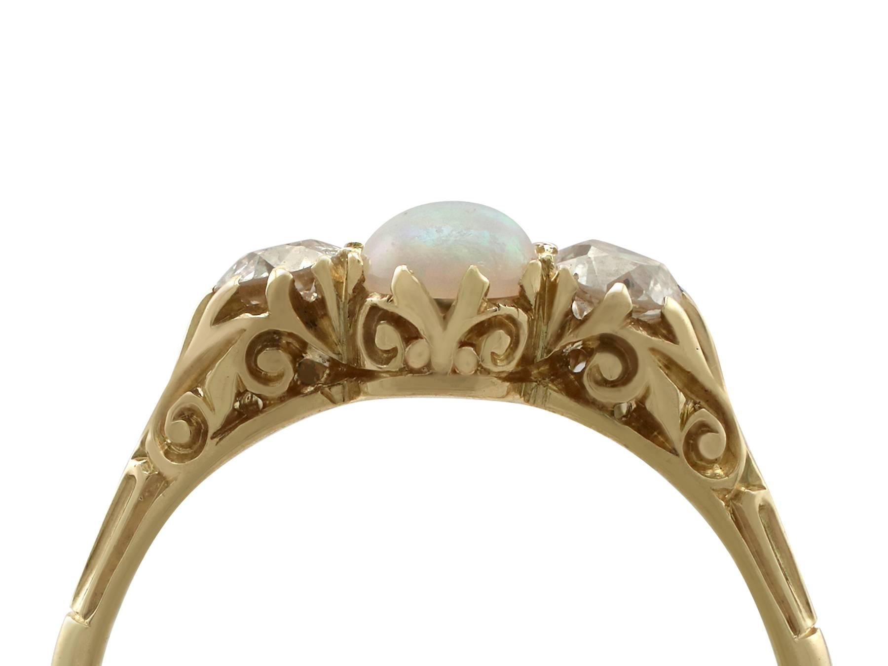 A fine and impressive 0.48 carat opal and 0.45 carat diamond, 18 karat yellow gold trilogy style dress ring; part of our diverse antique jewelry and estate jewelry collections

This fine and impressive antique opal and diamond ring has been crafted